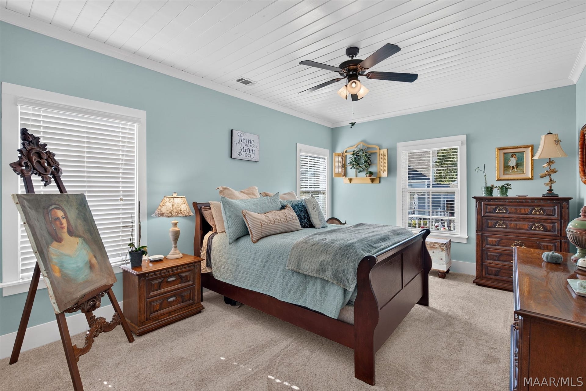 Downstairs primary with beautiful planked ceiling