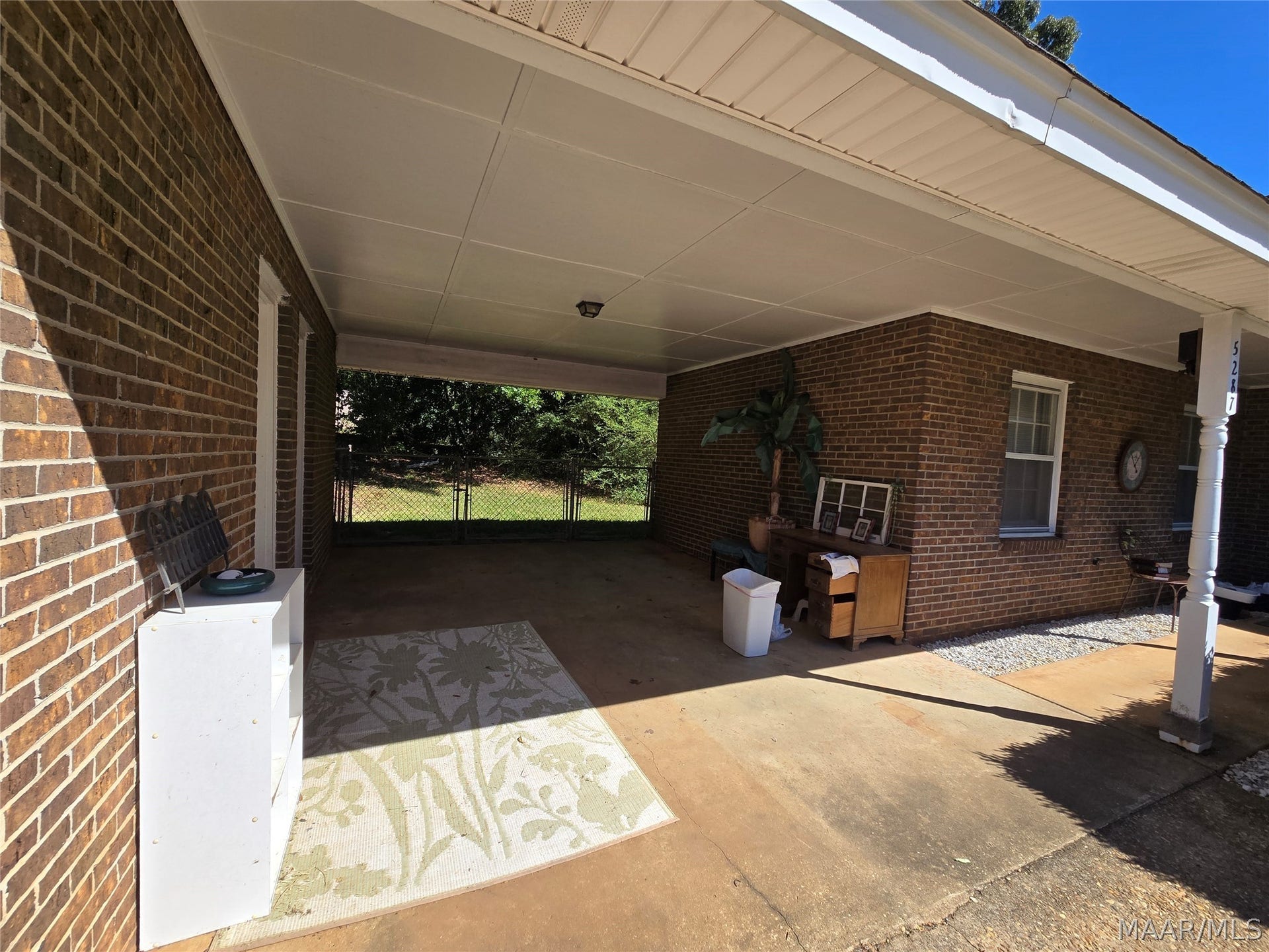 1 car carport, has double gate leading to back yard