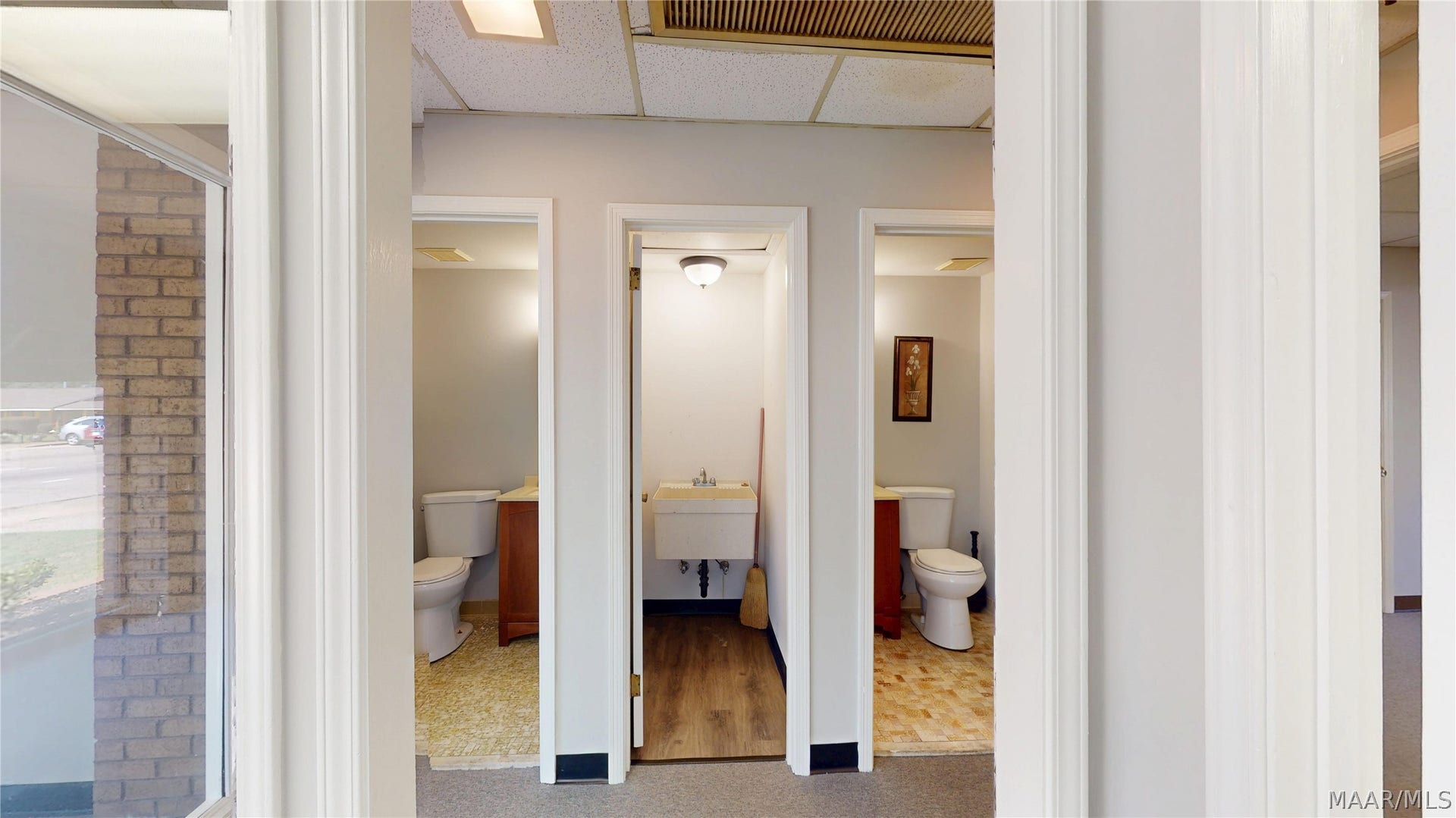 Suite D -Hall of bathrooms and utility closet with deep sink