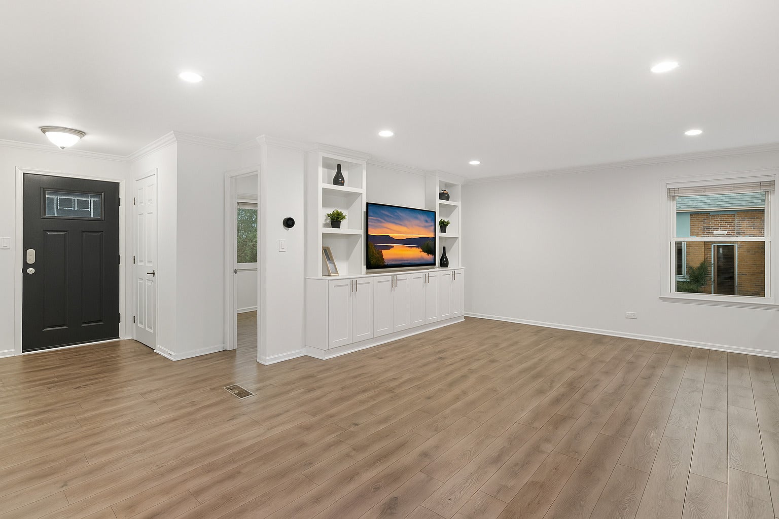 Living room view with built in entertainment cente