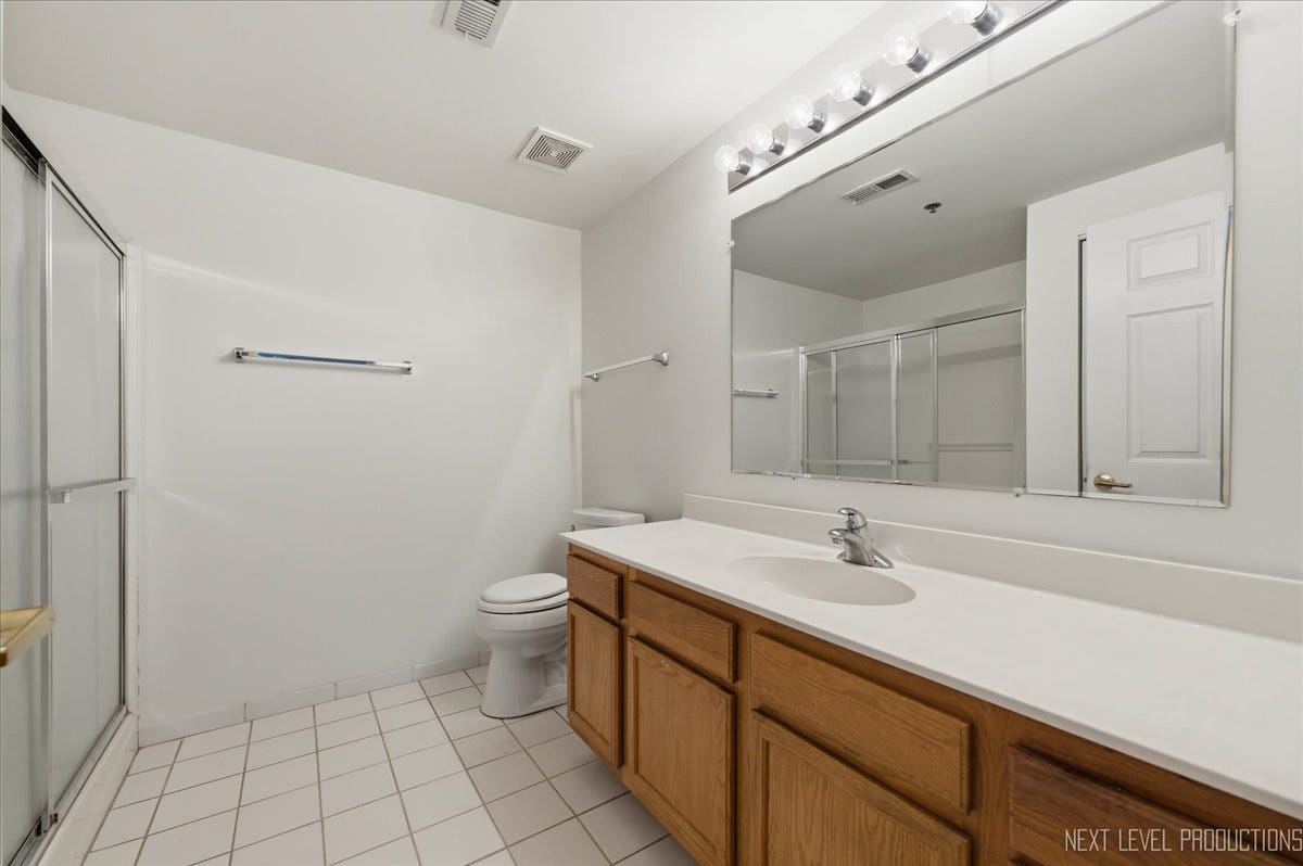 7841 W 157th Street, #104, Orland Park, IL 60462 Primary bath with a large vanity, walk-in shower,