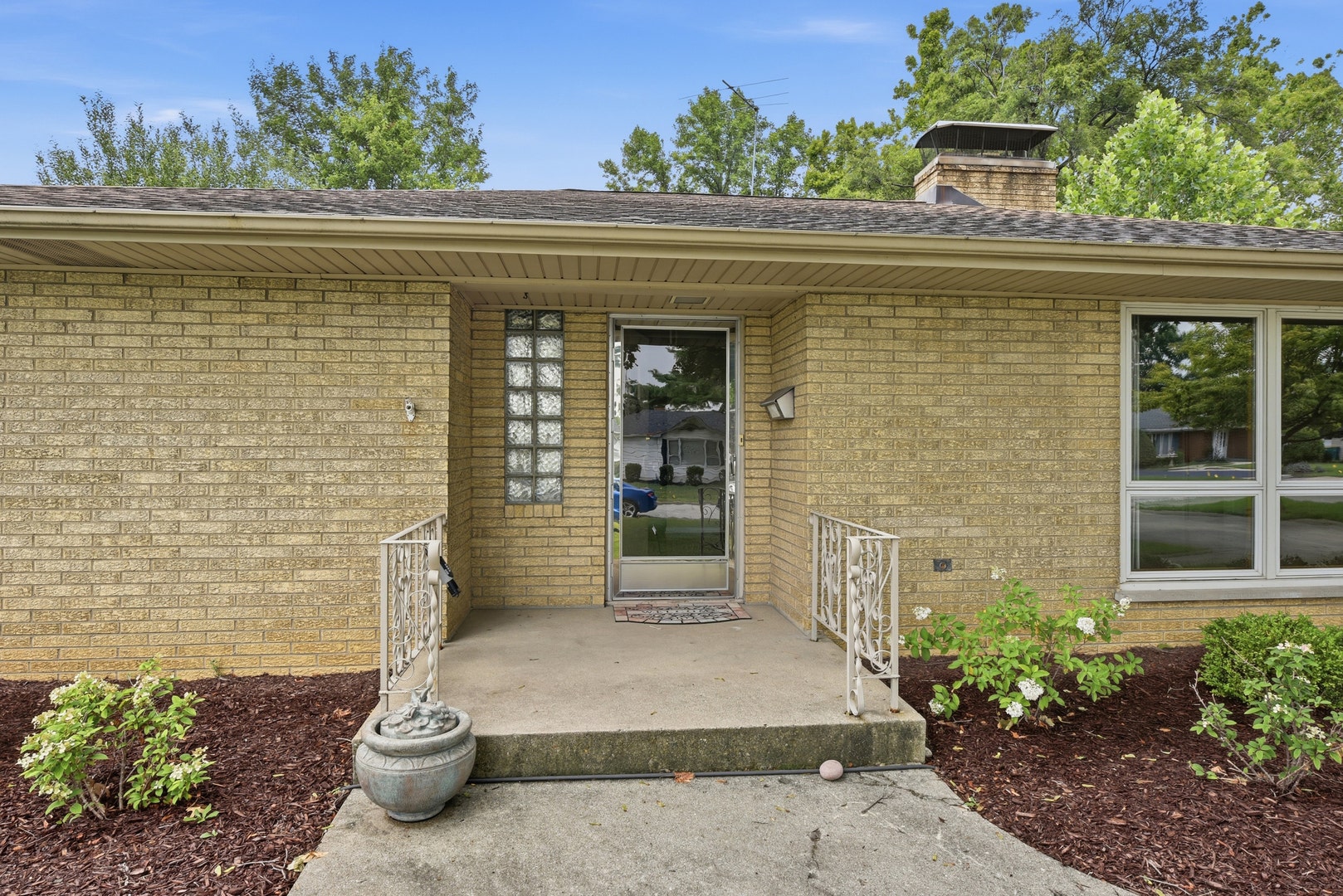 Main entry to the home offers a small porch where