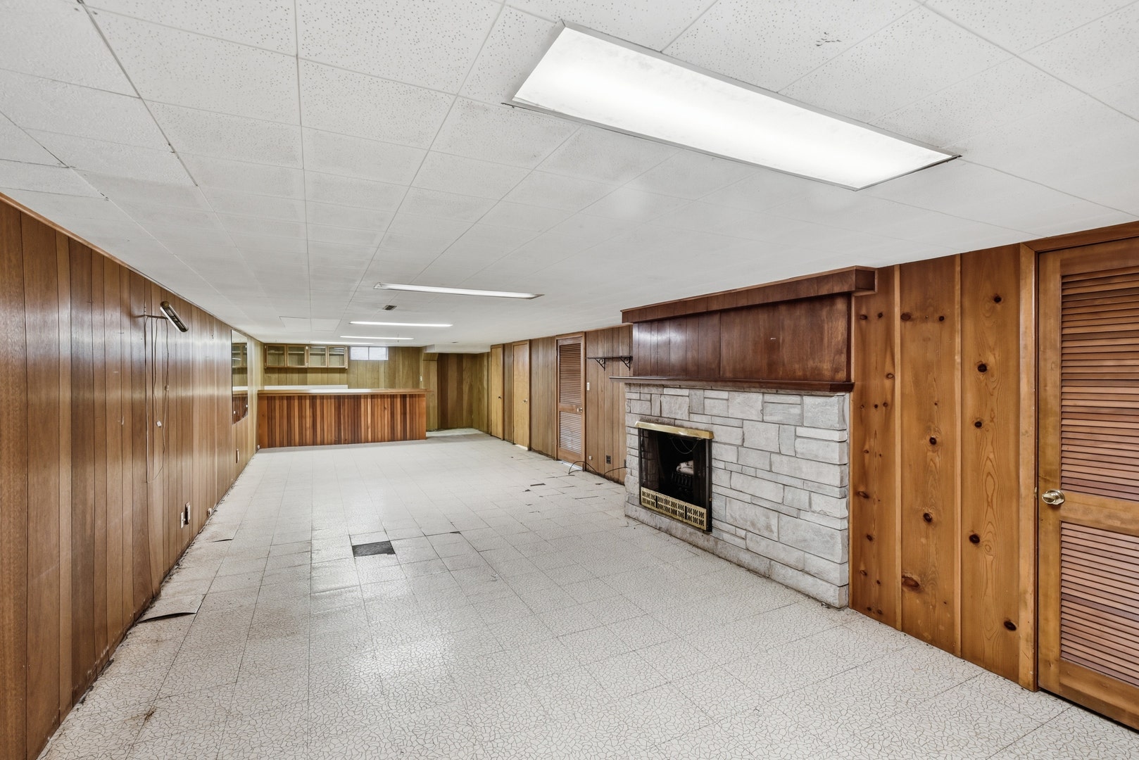 Family room in the partially finished basement wit