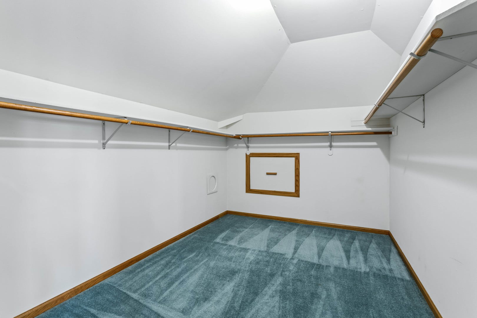 This walk in closet located in the primary suite a