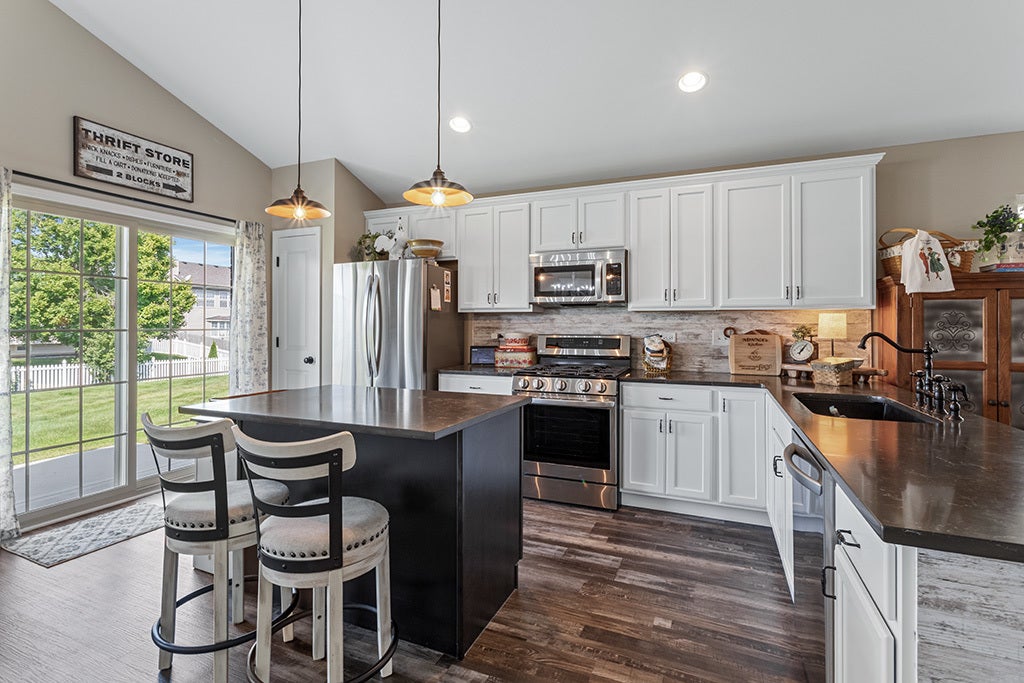 The kitchen showcases stainless stain appliances a