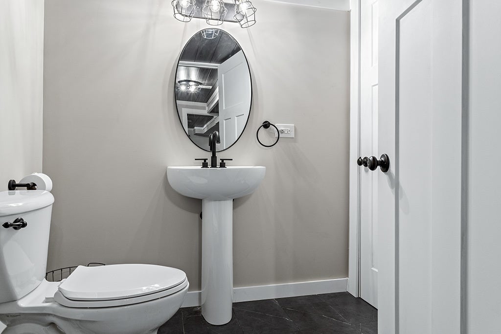 This half bathroom is attached to the 3rd bedroom