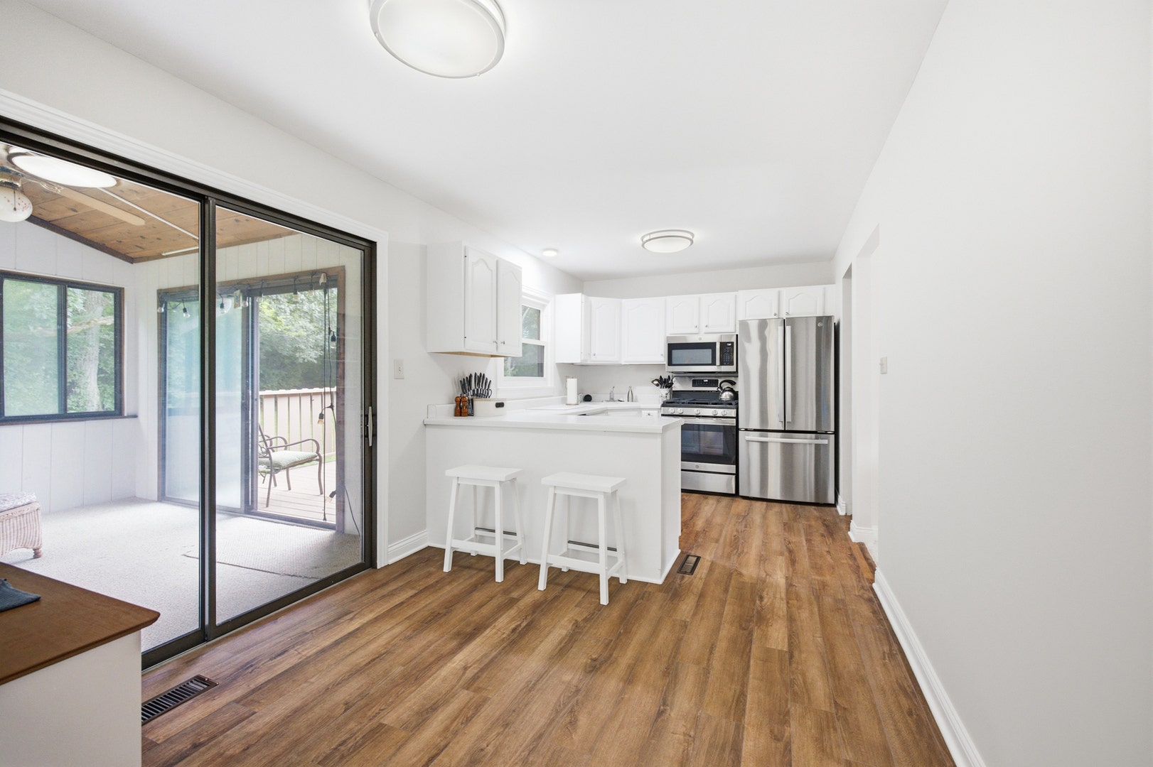 large eat-in kitchen with access to enclosed porch