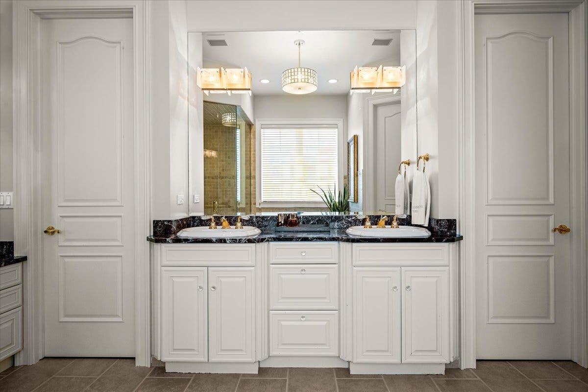 Features dual vanities, steam shower, separate tub