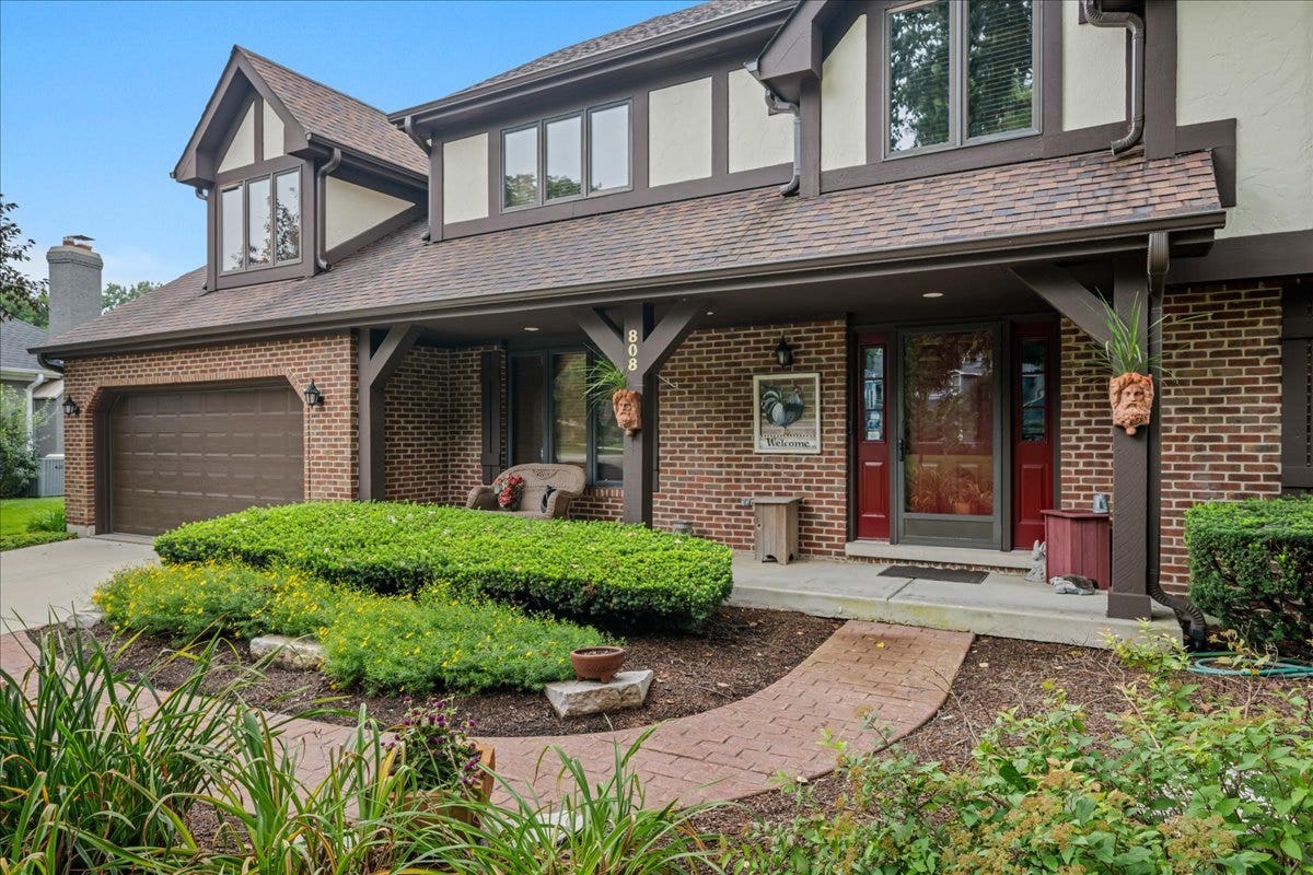 Welcoming front porch with gardens welcoming you a