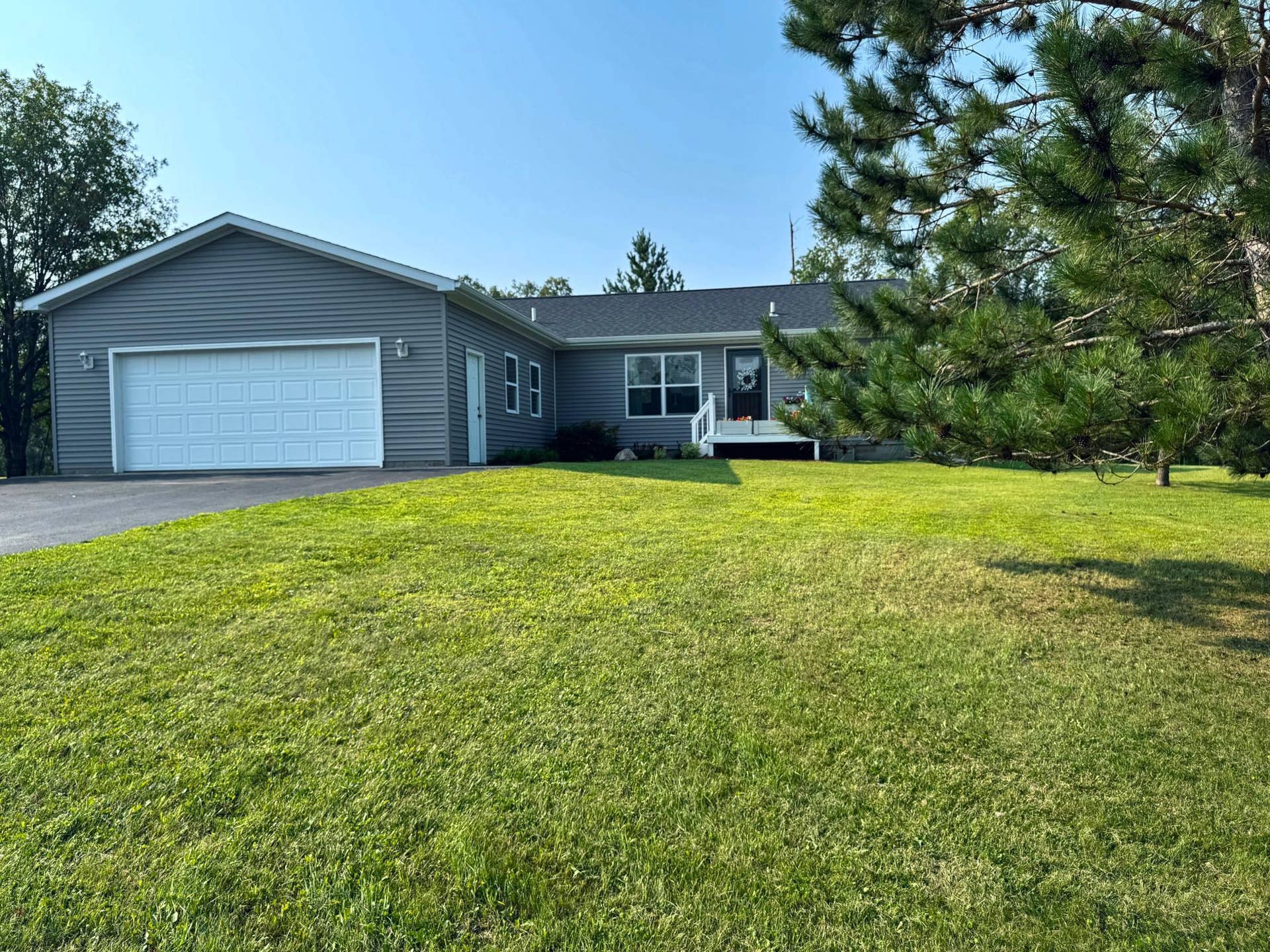 3790 Country Field Lane SW, Bemidji, MN 56601 front of the home through the pine trees.jpg