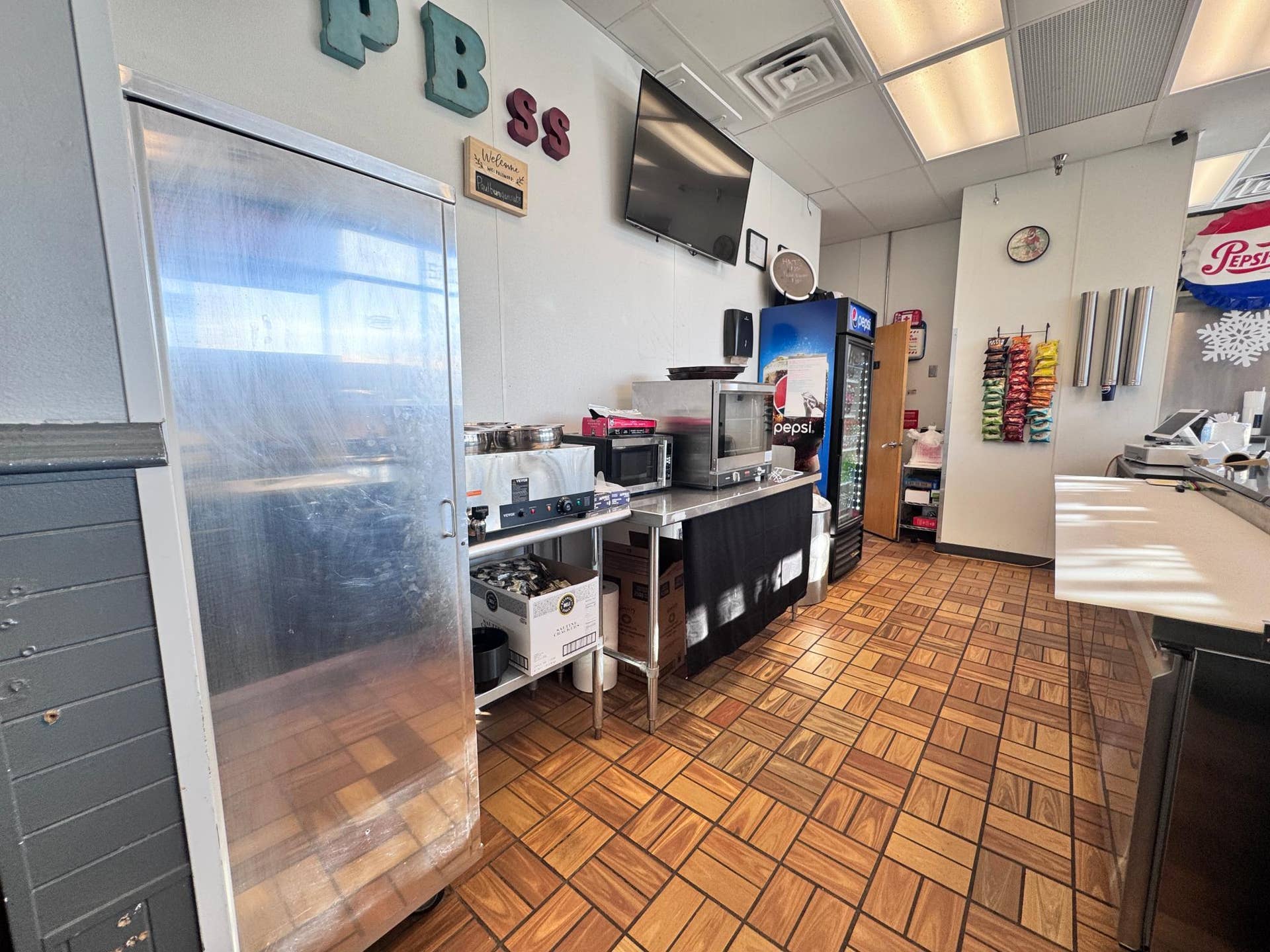119 2nd Street NW, Bemidji, MN 56601 The prep area is set up for a few employees to efficiently create customer orders. It includes a Bread Rack, 4 well warmer, Toaster oven, Coffee maker, Prep station and POS located at the end