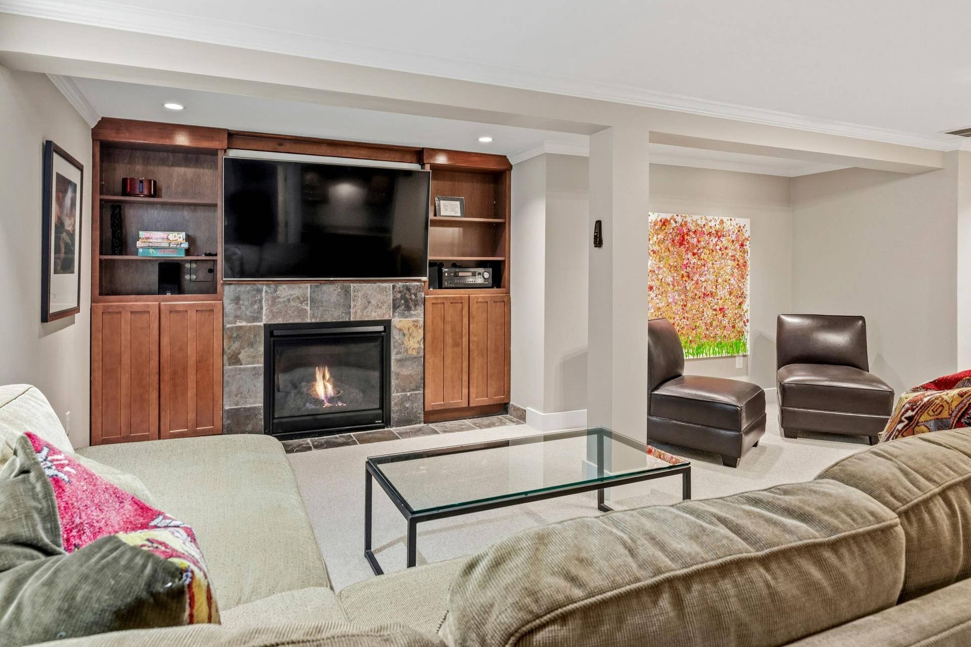 The expansive lower level provides an abundance of additional living space, offering a family room, walk up bar, home office, fitness space, two bedrooms and  bath.