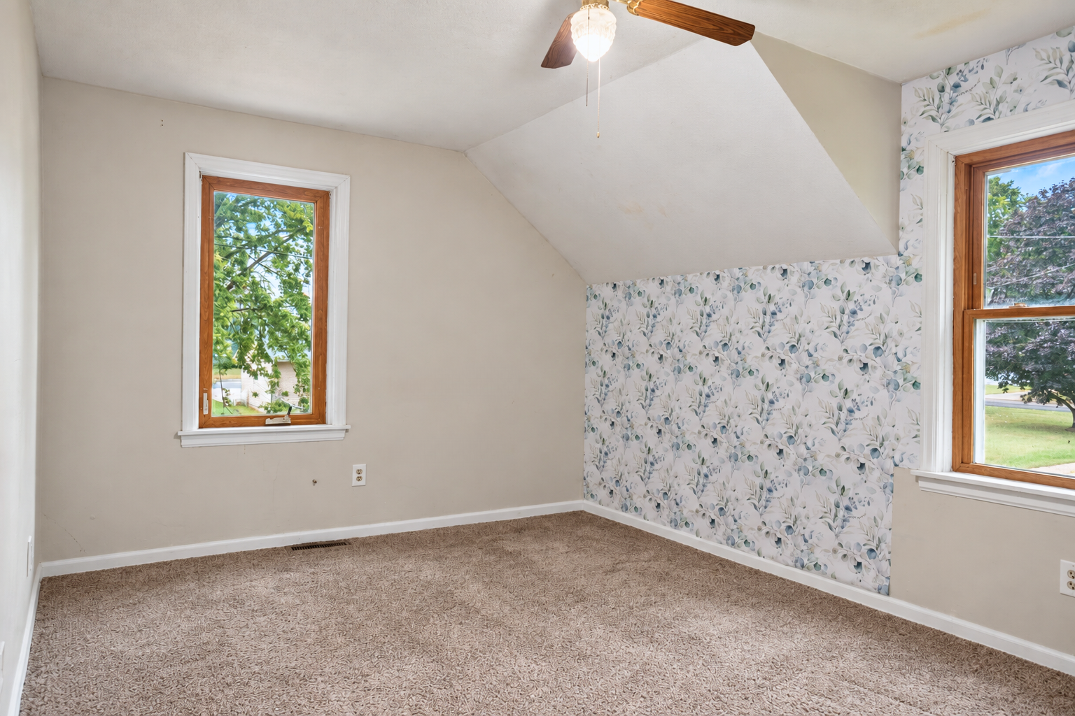 530 4th Street, Green Isle, MN 55338 Spacious primary bedroom with newer carpeting, abundant natural light and room for a king-sized bed and additional furnishings.