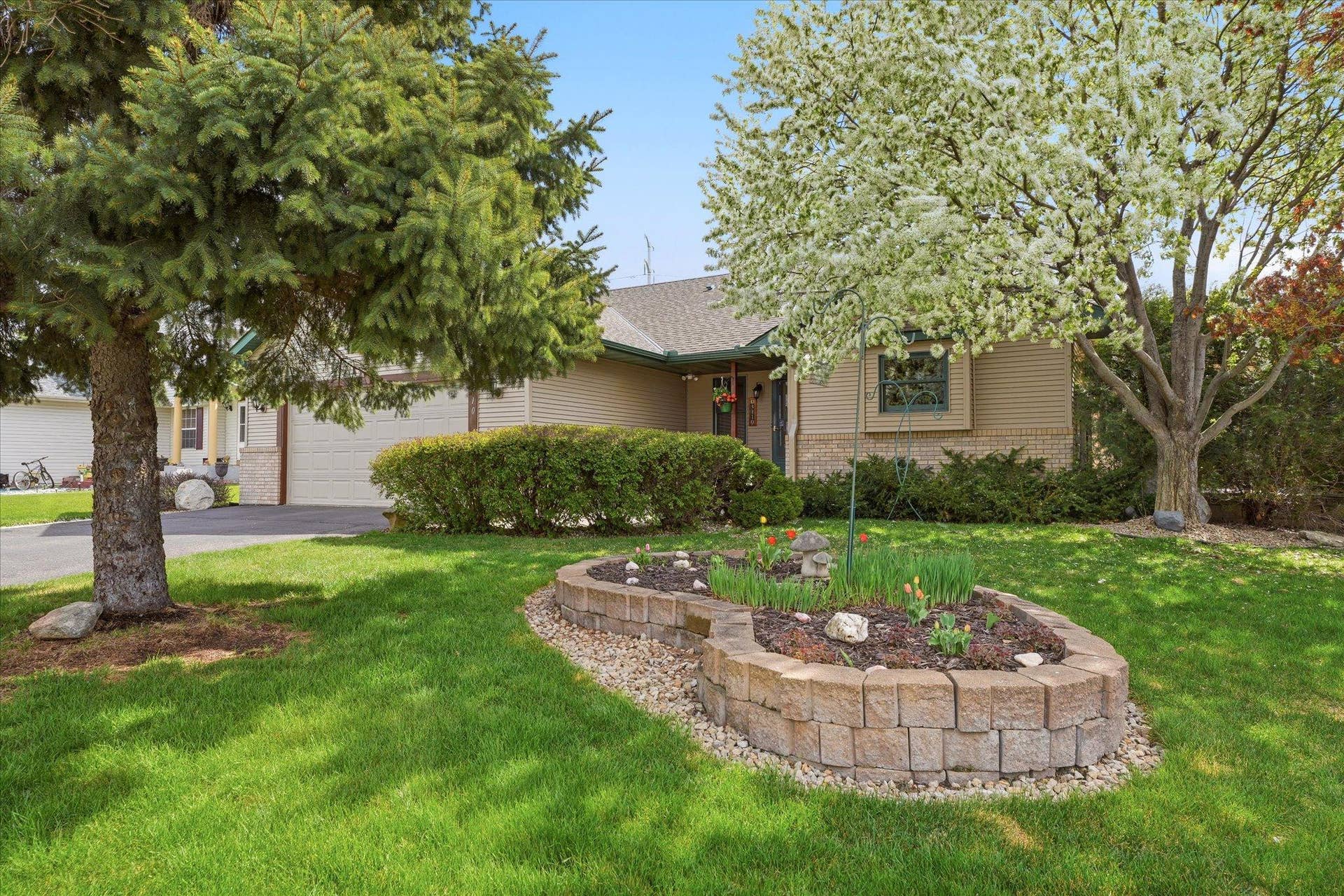3110 Bluebell Avenue N, Brooklyn Park, MN 55443 Well-maintained landscaping enhances the front exterior, creating a welcoming first impression filled with charm and character. The mature greenery adds privacy and highlights the homes beautiful setting.