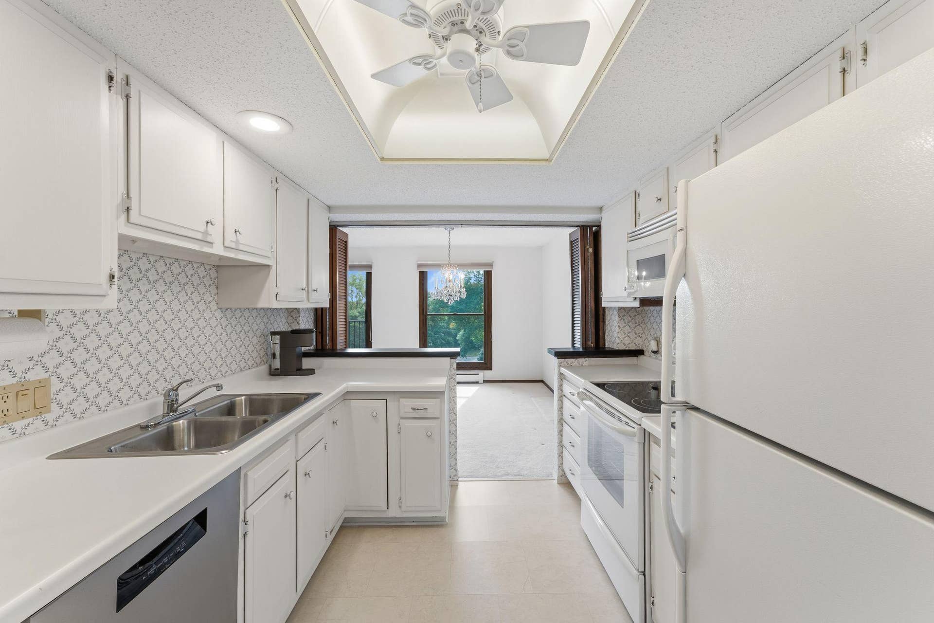 The kitchen offers ample cabinets and counter space