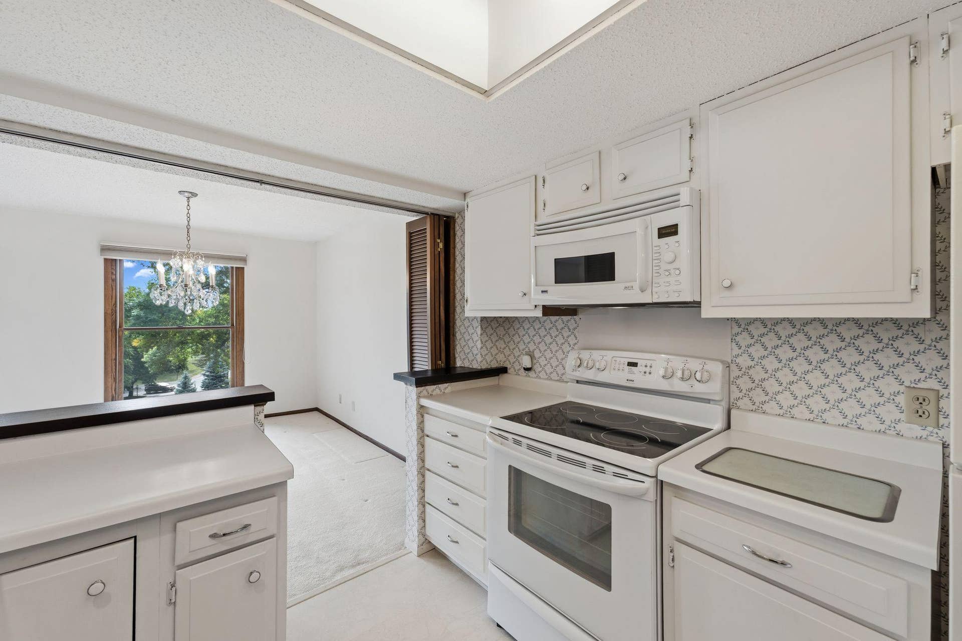 The bright, white kitchen is airy and light.