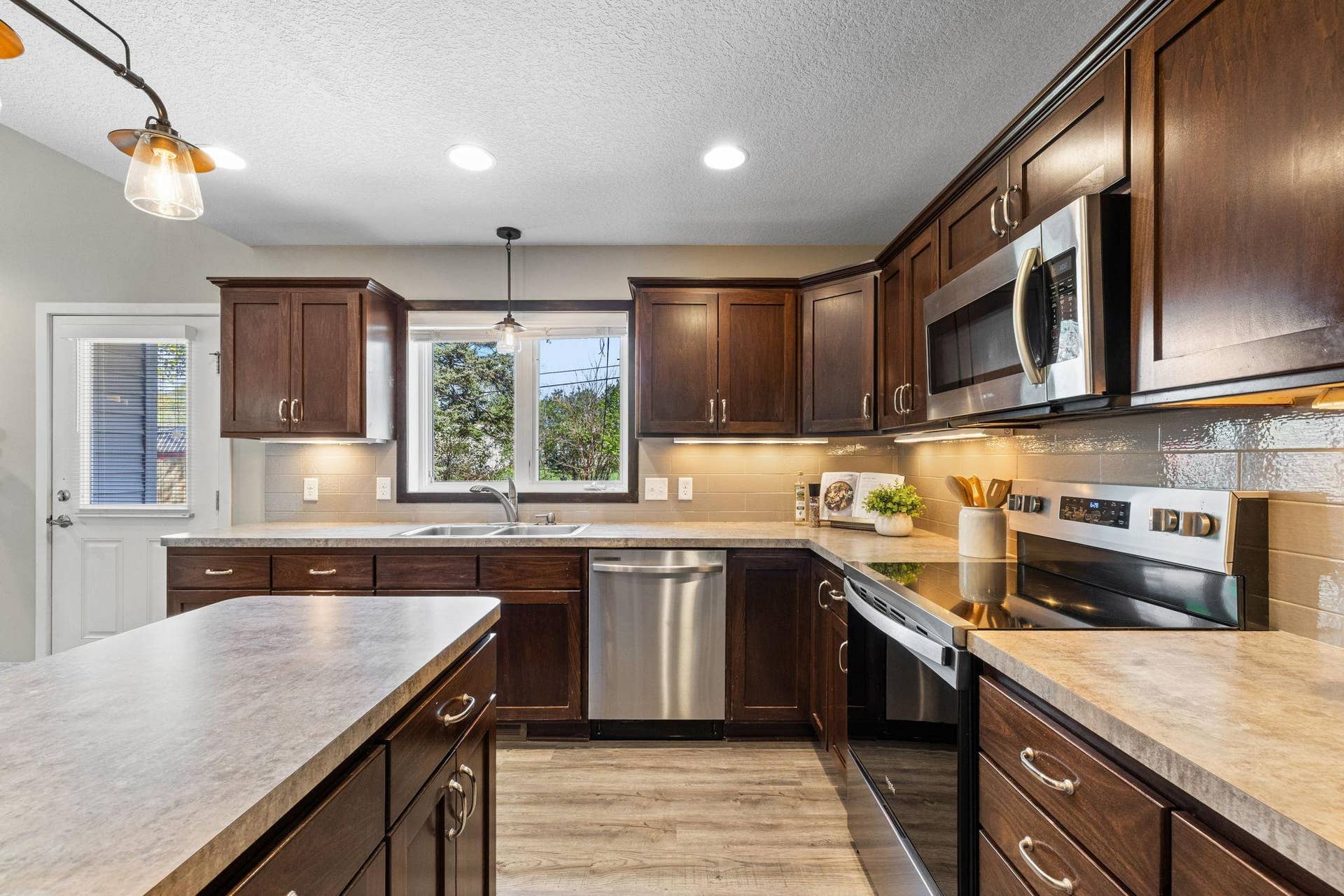 319 Bellwood Avenue, Maplewood, MN 55117 The kitchen is both stylish and functional, featuring stainless steel appliances and tile backsplash.