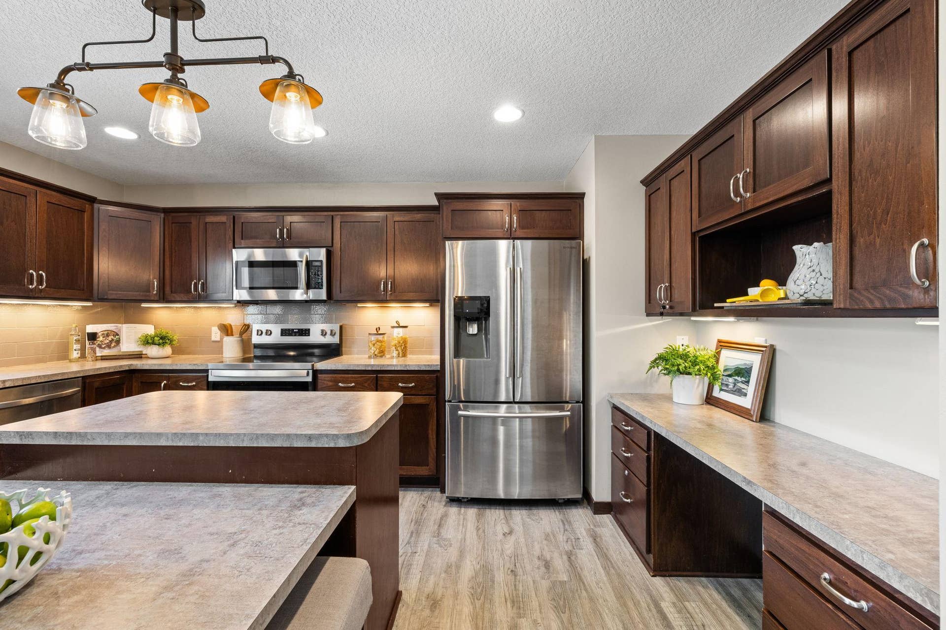 319 Bellwood Avenue, Maplewood, MN 55117 Walk-in pantry, under-cabinet lighting, and a built-in desk and drop zone for added organization.