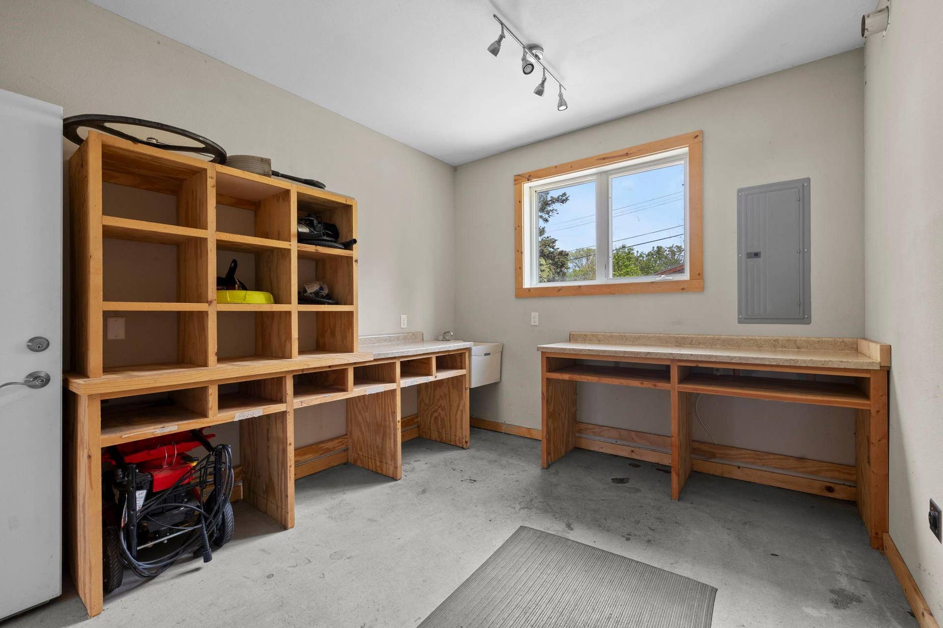 319 Bellwood Avenue, Maplewood, MN 55117 Connected workshop space featuring a workbench and shelving, ideal for tools, projects, and additional storage.