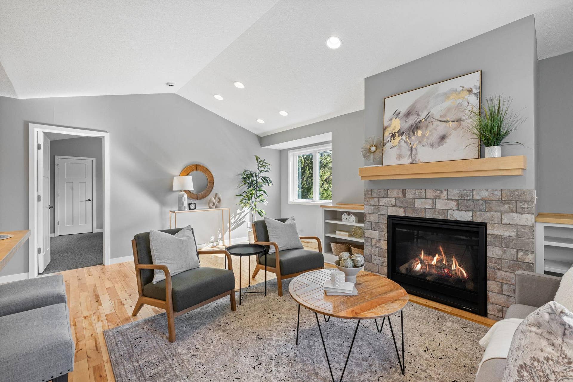 319 Bellwood Avenue, Maplewood, MN 55117 The connected living and dining area showcases a gas fireplace with stone surround and built-ins.