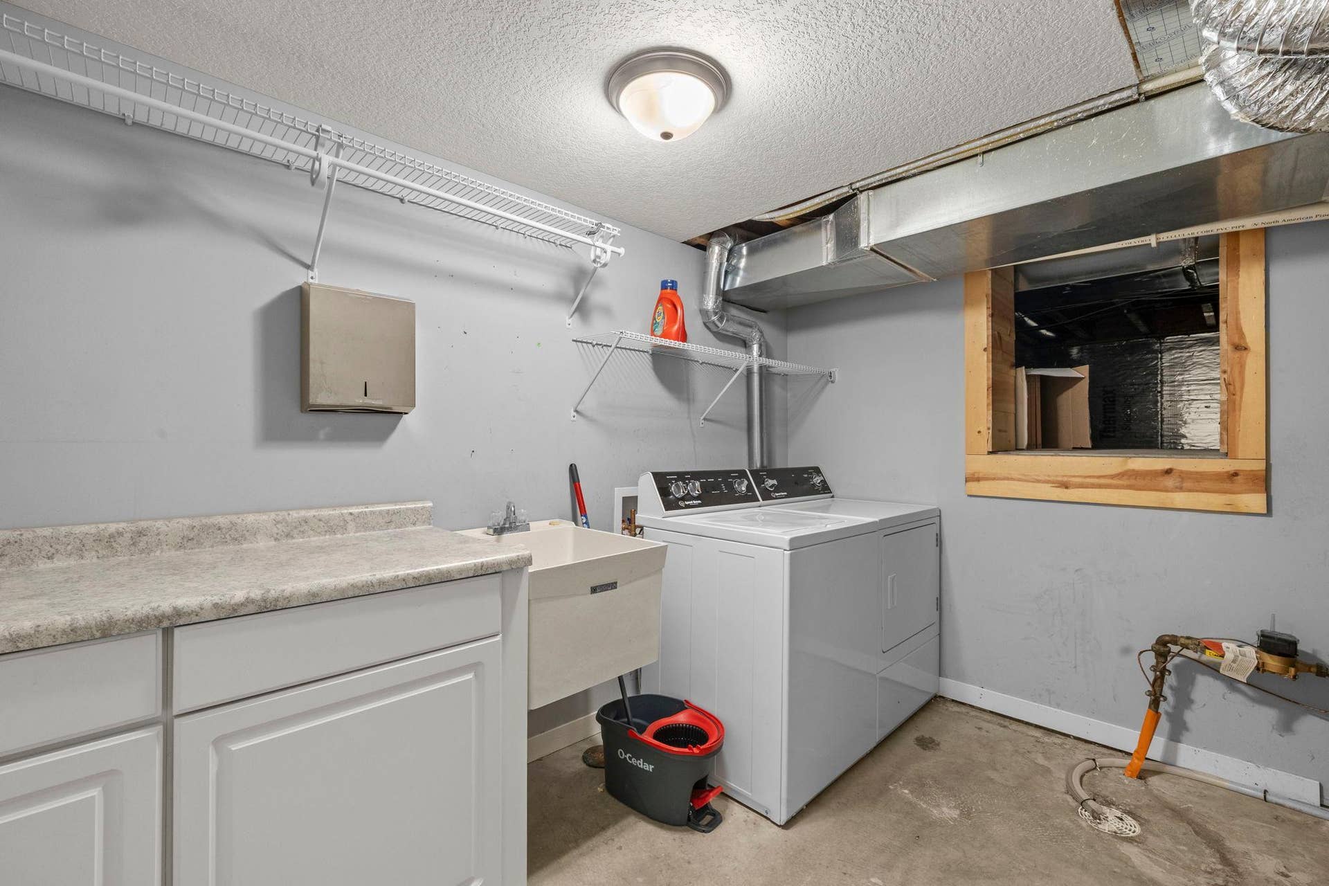 319 Bellwood Avenue, Maplewood, MN 55117 The laundry space is located on the lower level, featuring Speed Queen washer and dryer, cabinetry, counter space, and shelving with a nearby 47x11 crawl space that provides extensive additional storage.