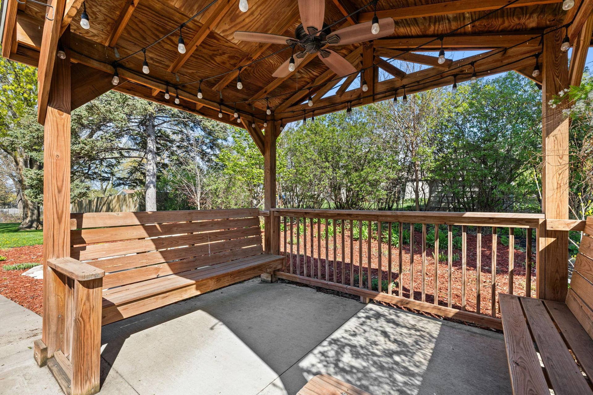 319 Bellwood Avenue, Maplewood, MN 55117 A built-in wood gazebo with lighting and bench seating creates a welcoming retreat for outdoor enjoyment.