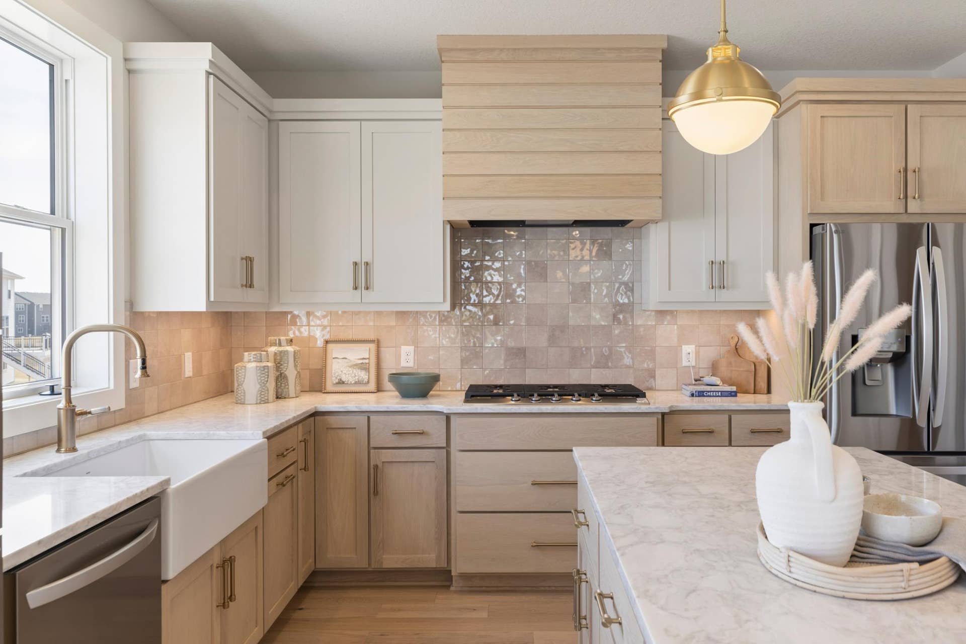 5003 Airlake Drive, Woodbury, MN 55129 Large fireclay kitchen sink surrounded by beautiful quartz countertops.
