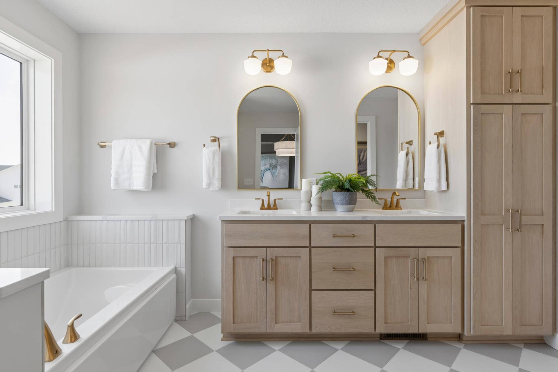 5003 Airlake Drive, Woodbury, MN 55129 Primary bath features double sink vanity with quartz countertops and linen cabinet.