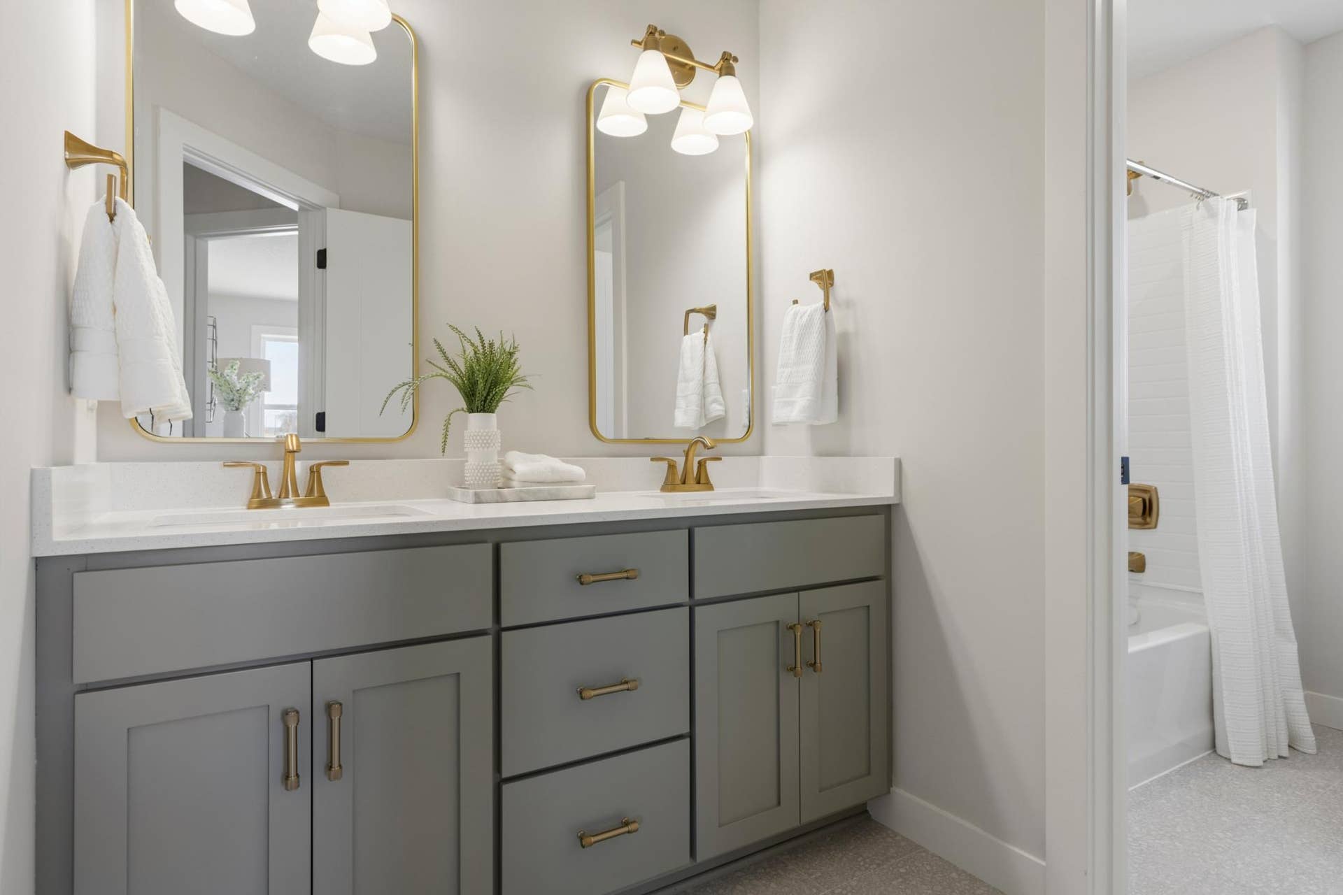 5003 Airlake Drive, Woodbury, MN 55129 Double vanity with quartz countertops and separate room for tub.
