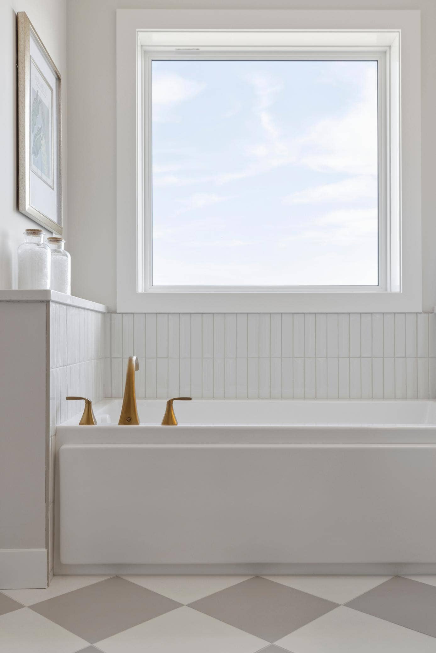 5003 Airlake Drive, Woodbury, MN 55129 Tub with large window and beautiful tile backsplash in primary bath.
