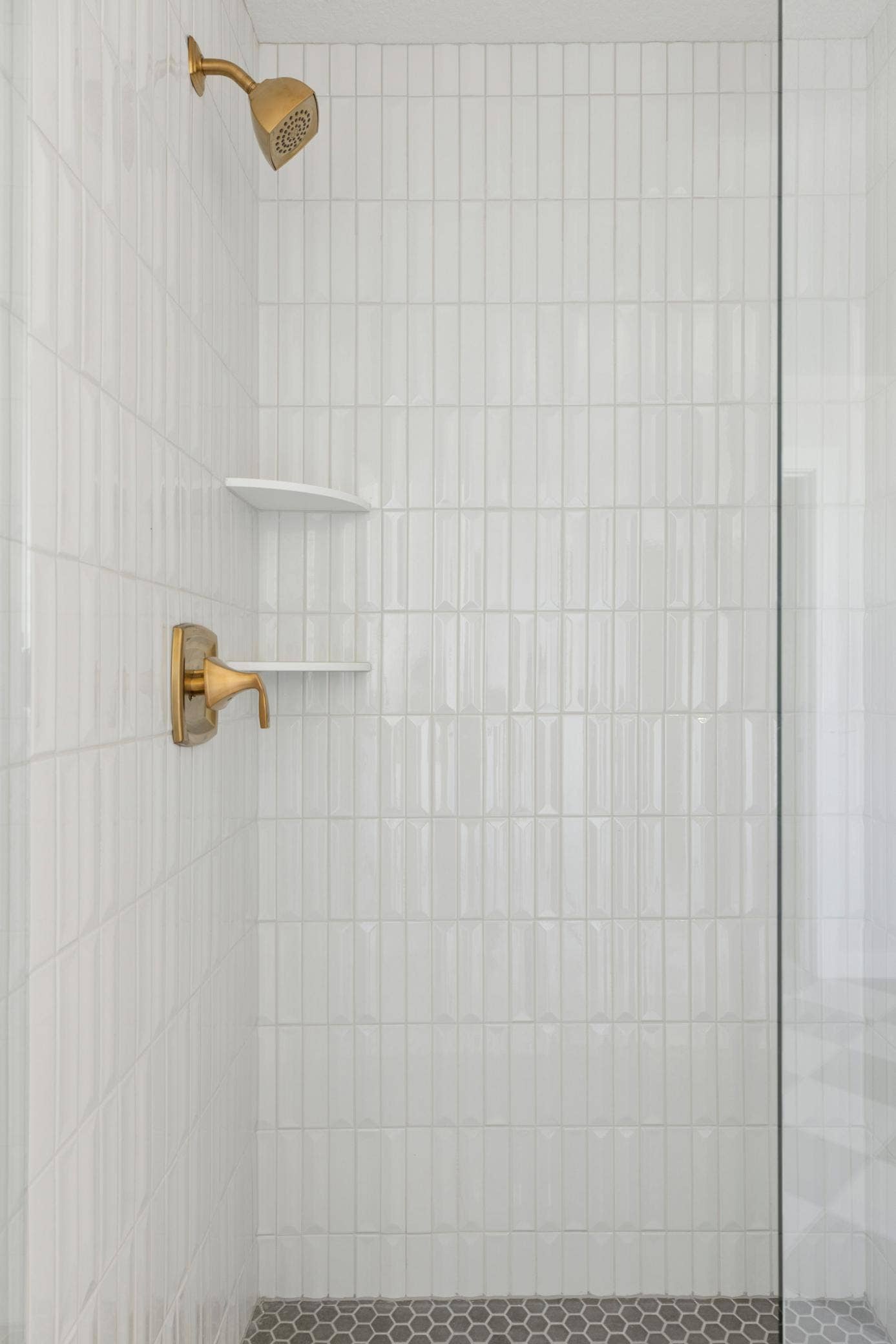 5003 Airlake Drive, Woodbury, MN 55129 Primary bath shower features frameless shower door, tile walls and tile floor.