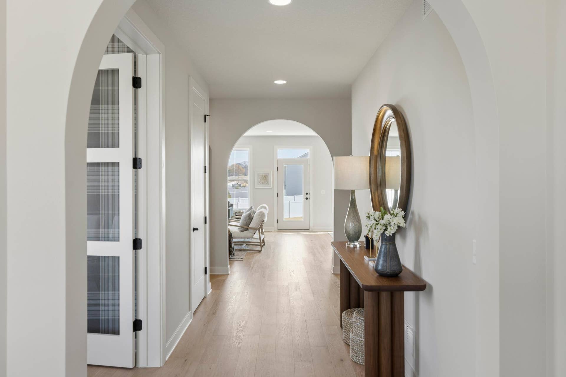 5003 Airlake Drive, Woodbury, MN 55129 Foyer features graceful arched openings and wide-planked oak floors.
