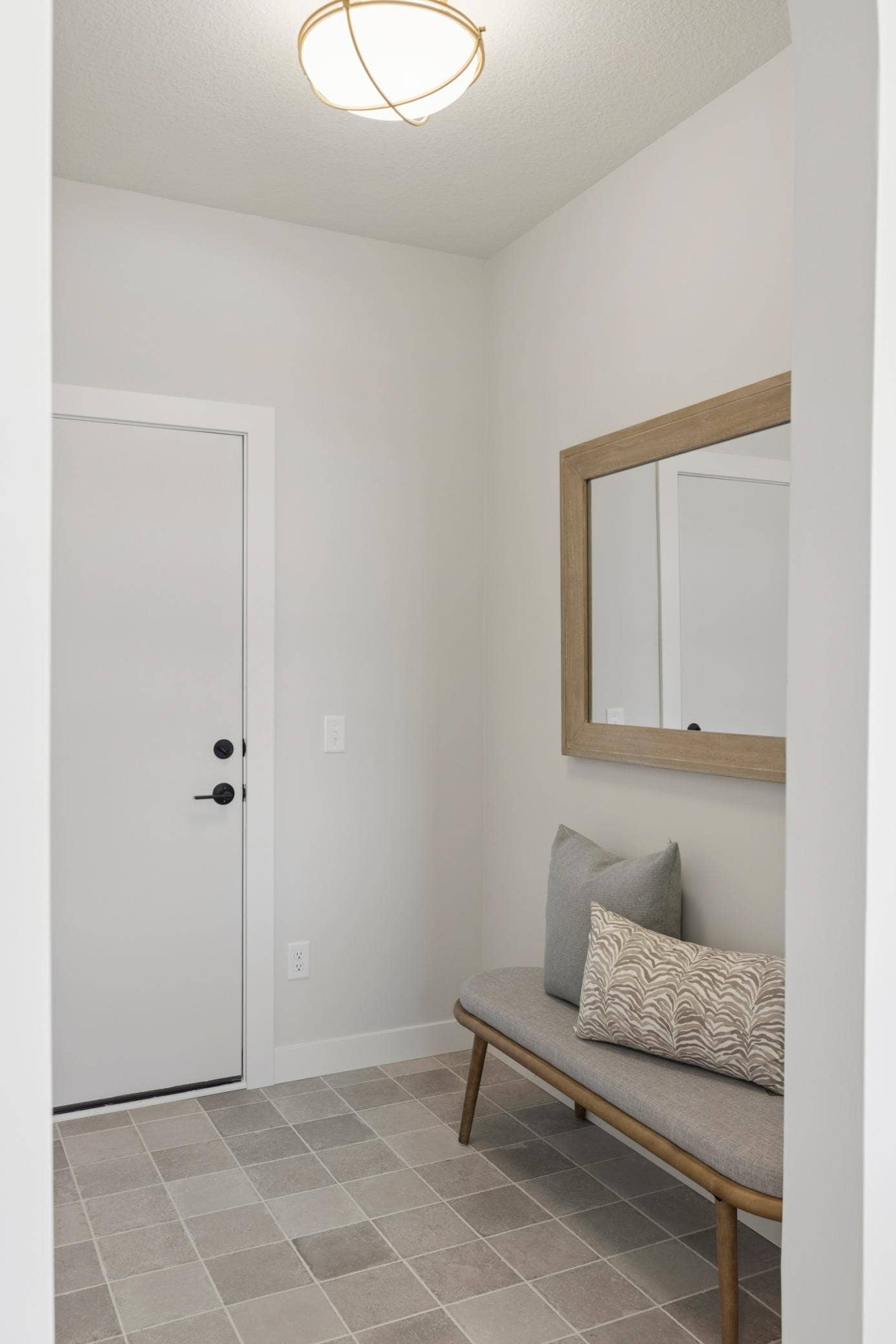 5003 Airlake Drive, Woodbury, MN 55129 Mudroom off three car garage features walk-in coat closet and stunning tile.