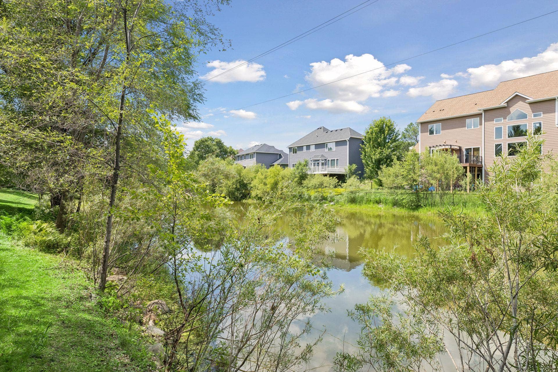OVERLOOKS A BEAUTIFUL NEIGHBORHOOD POND