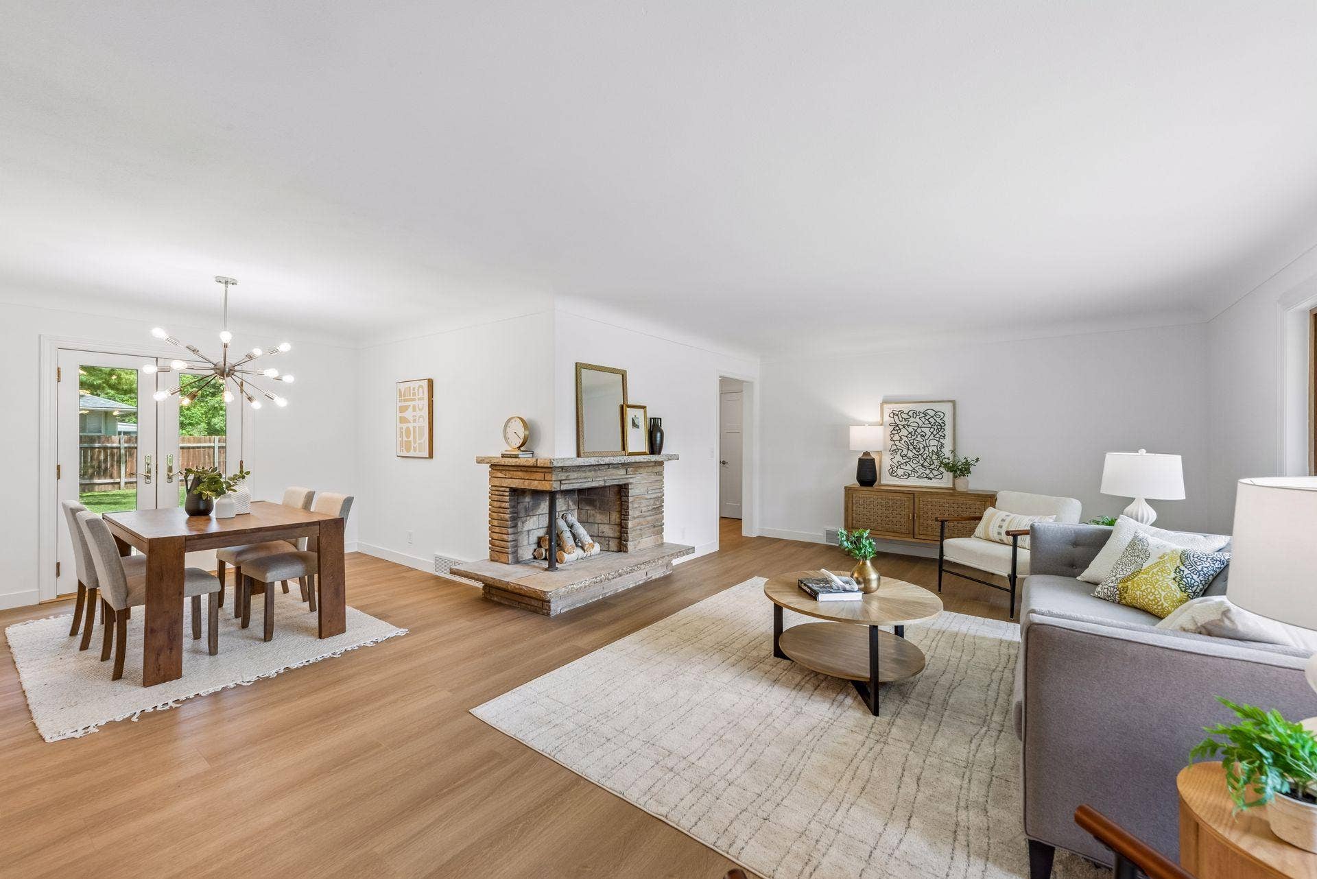 25x15 and 11x9 Living room and dining room with south and north-facing updated windows, new paint, new luxury vinyl flooring, and lighting.