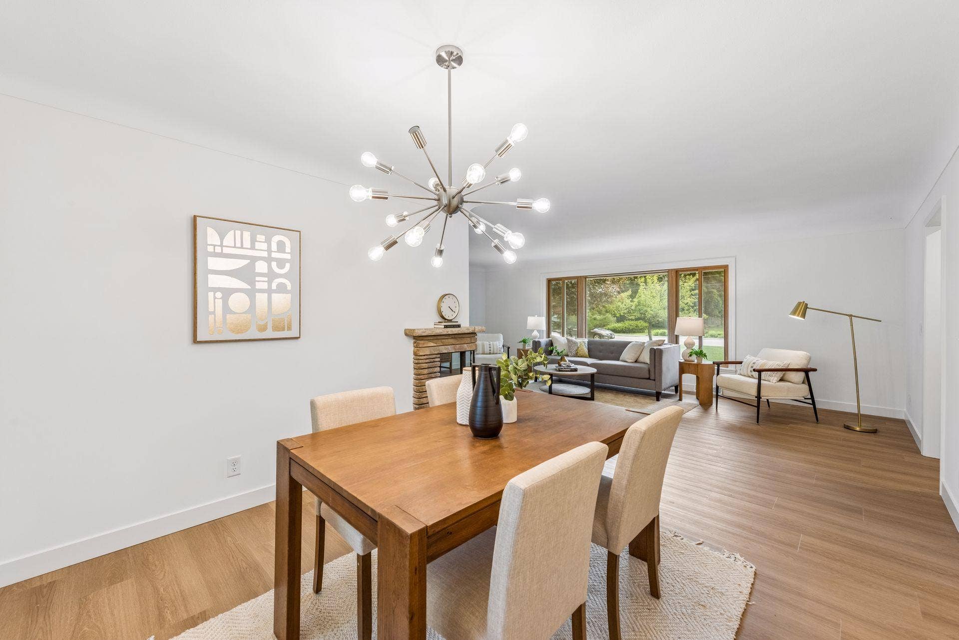 25x15 and 11x9 Living room and dining room with south and north-facing updated windows, new paint, new luxury vinyl flooring, and lighting.