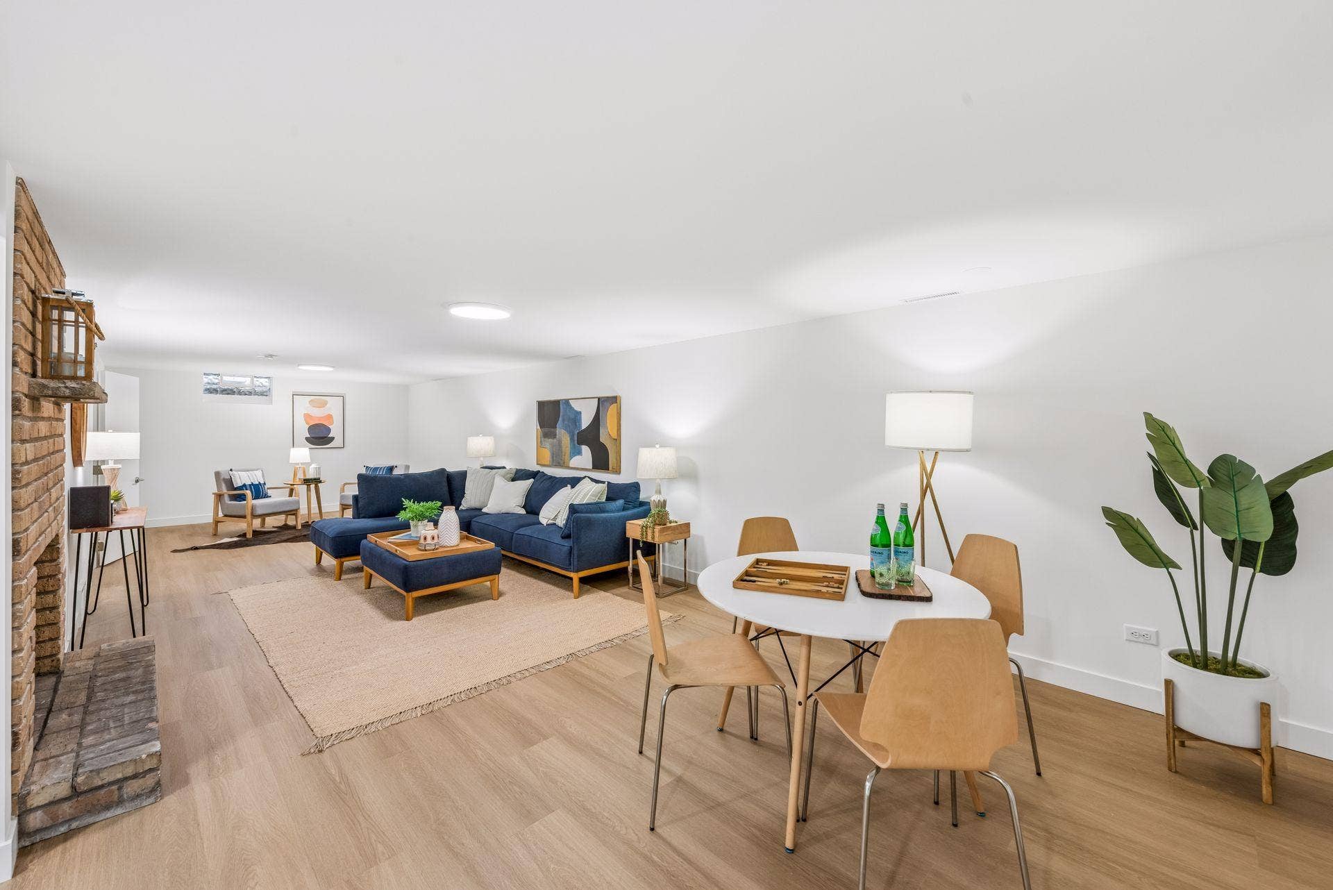 34x14 Lower level Family room with East-facing updated glass block windows, new paint, new luxury vinyl flooring, and lighting.