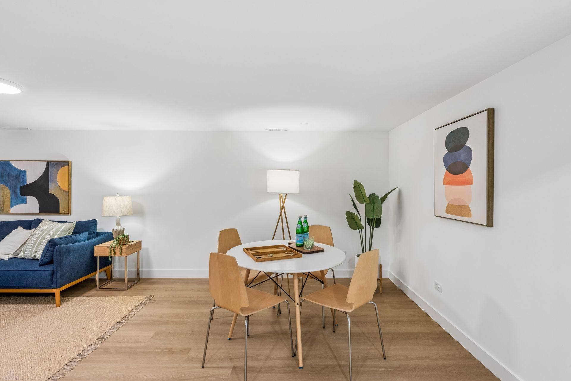34x14 Lower level Family room with East-facing updated glass block windows, new paint, new luxury vinyl flooring, and lighting.