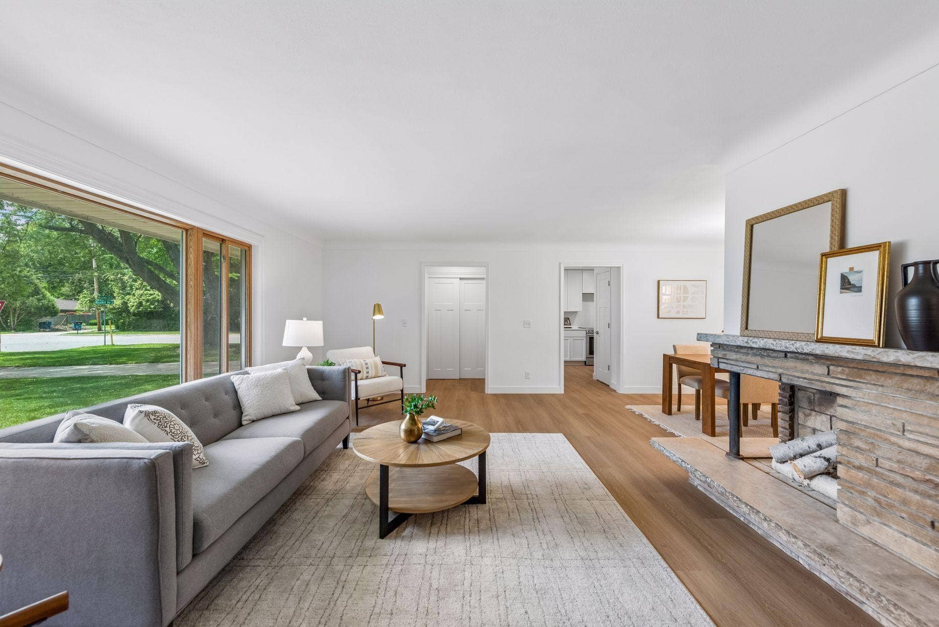 25x15 and 11x9 Living room and dining room with south and north-facing updated windows, new paint, new luxury vinyl flooring, and lighting.