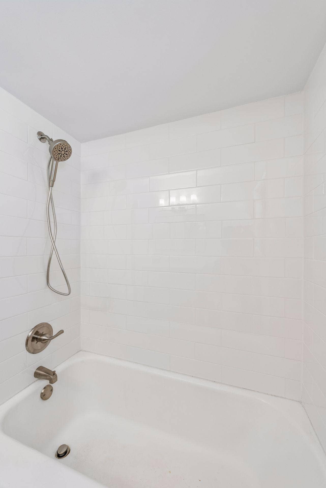 Main Floor: Full bathroom with updated Subway tile, White oak Room and Board vanity with marble top and Mirror, New toilet, New lighting, and Marble flooring