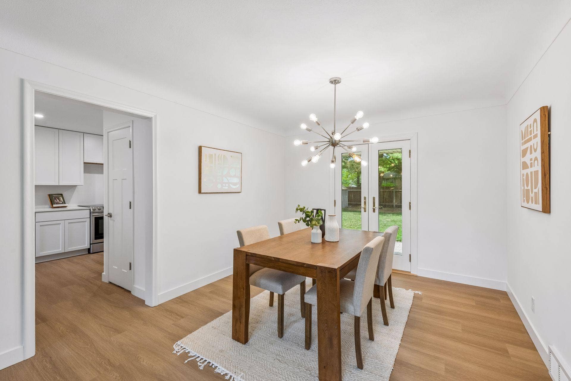 25x15 and 11x9 Living room and dining room with south and north-facing updated windows, new paint, new luxury vinyl flooring, and lighting.