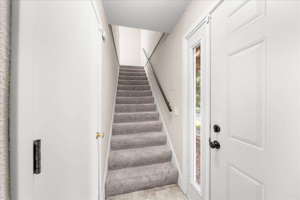 Front entrance, stirs leading to main living area
