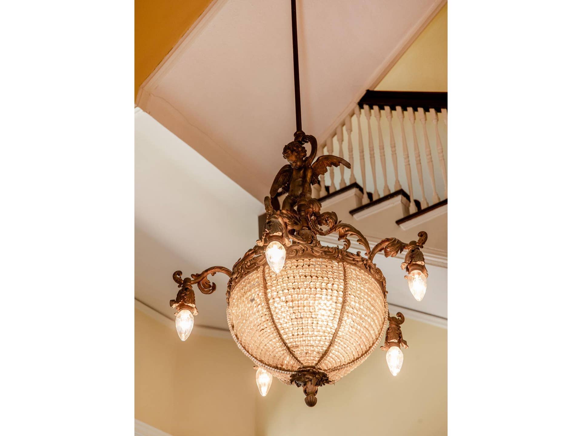 661 Fairmount Avenue, 100, Saint Paul, MN 55105 An elaborate crystal basket chandelier, accented with cherub figures and ornate bronze detailing, illuminates the foyer with Old World sophistication