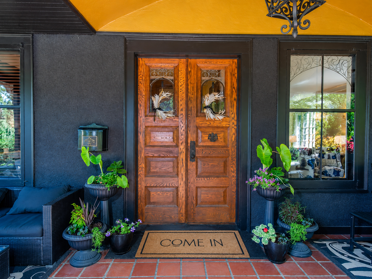 661 Fairmount Avenue, 100, Saint Paul, MN 55105 A welcoming covered entry showcases rich wood double doors with leaded glass, framed by a warm barrel-vaulted ceiling and classic wrought-iron lantern with terra cotta tile create a timeless an unmistakable first impression
