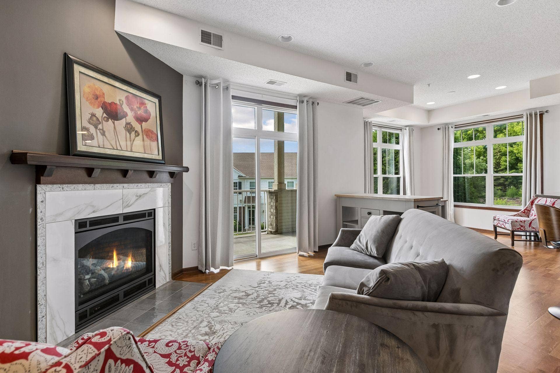 The living room is anchored by a gas fireplace, providing a natural gathering space.