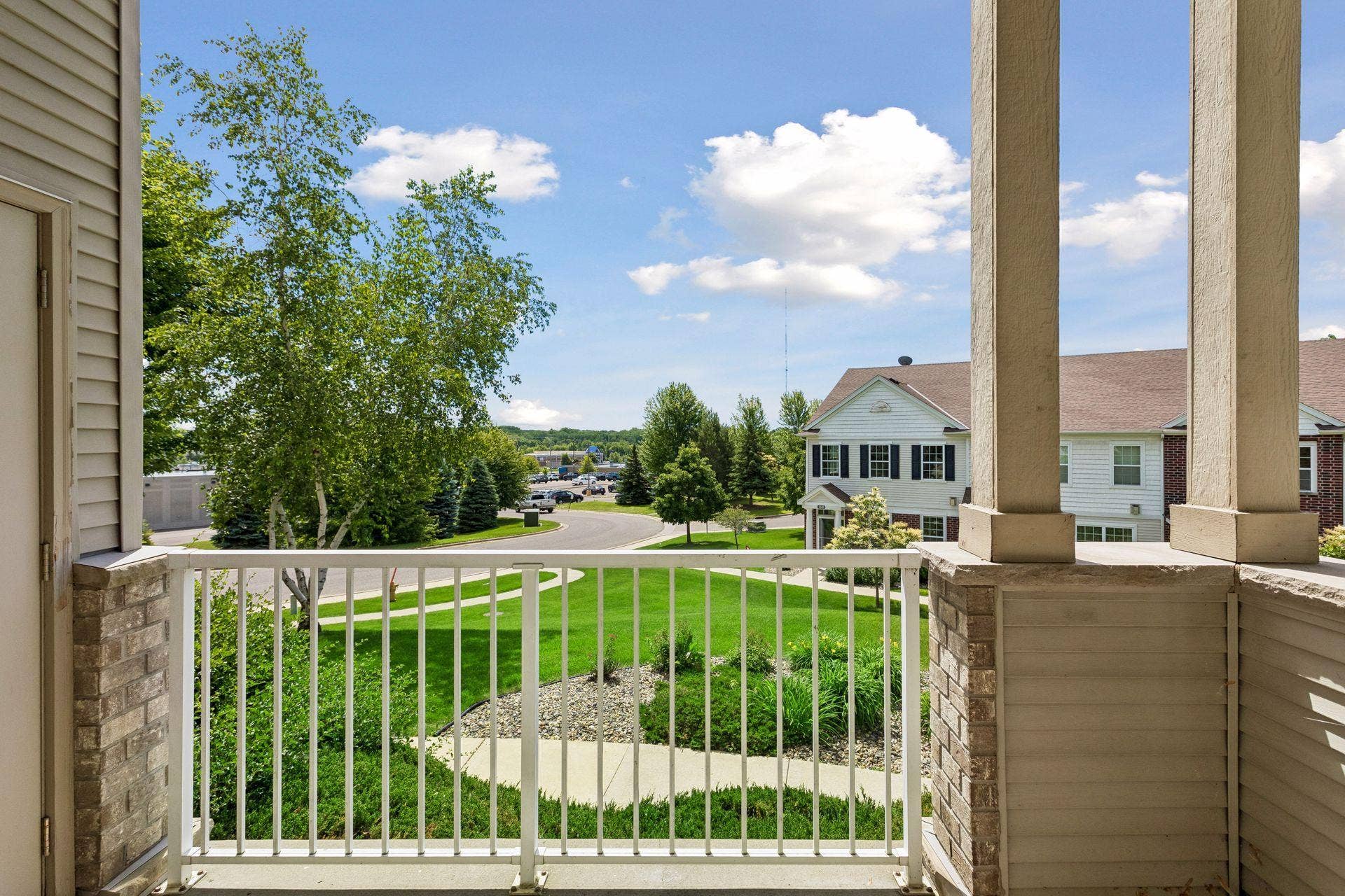 A private covered porch extends the living area outdoors, offering a comfortable setting for morning coffee, quiet afternoons, or evenings spent enjoying the surrounding greenery.