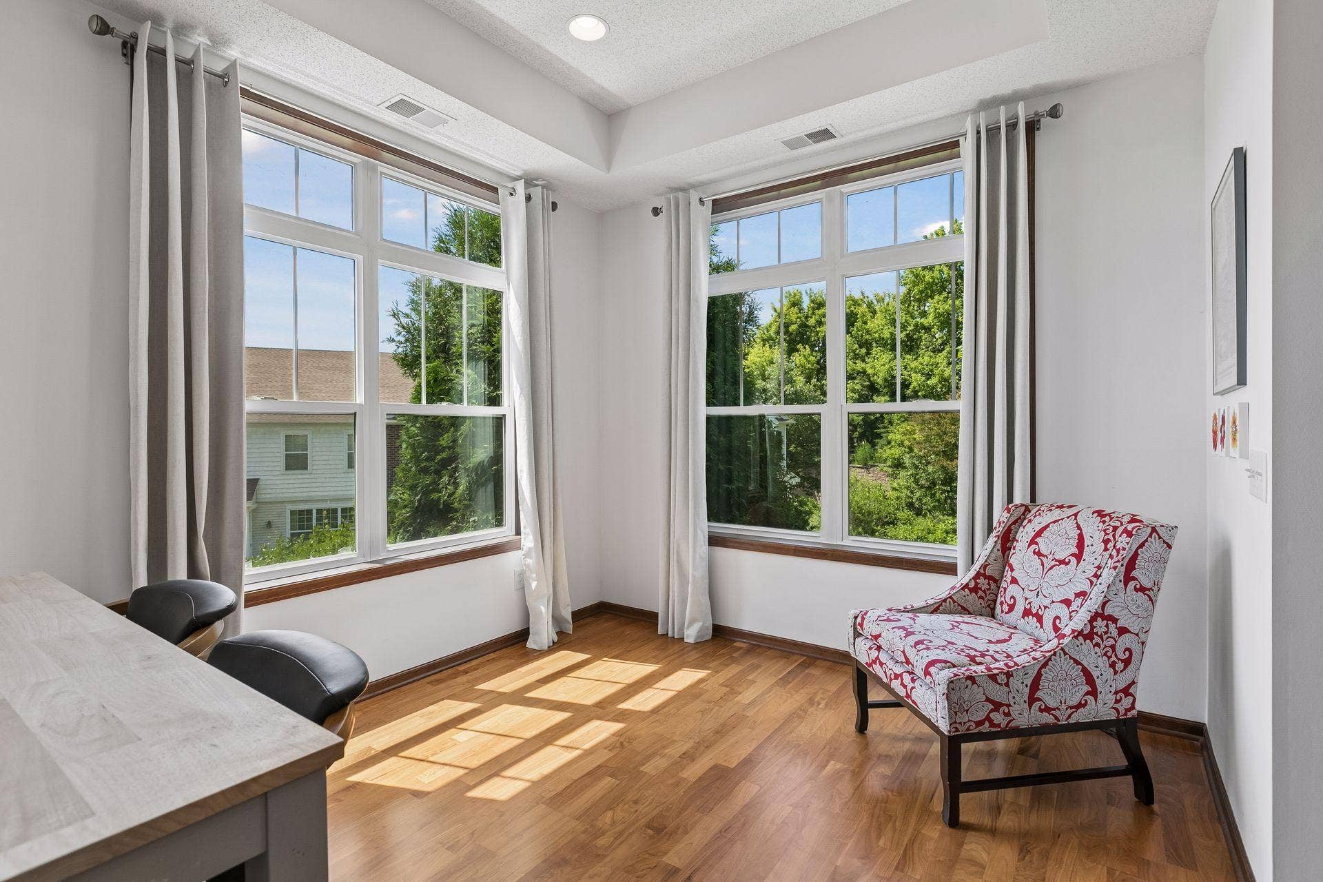 The dining area is wrapped in windows that draw in natural light throughout the day