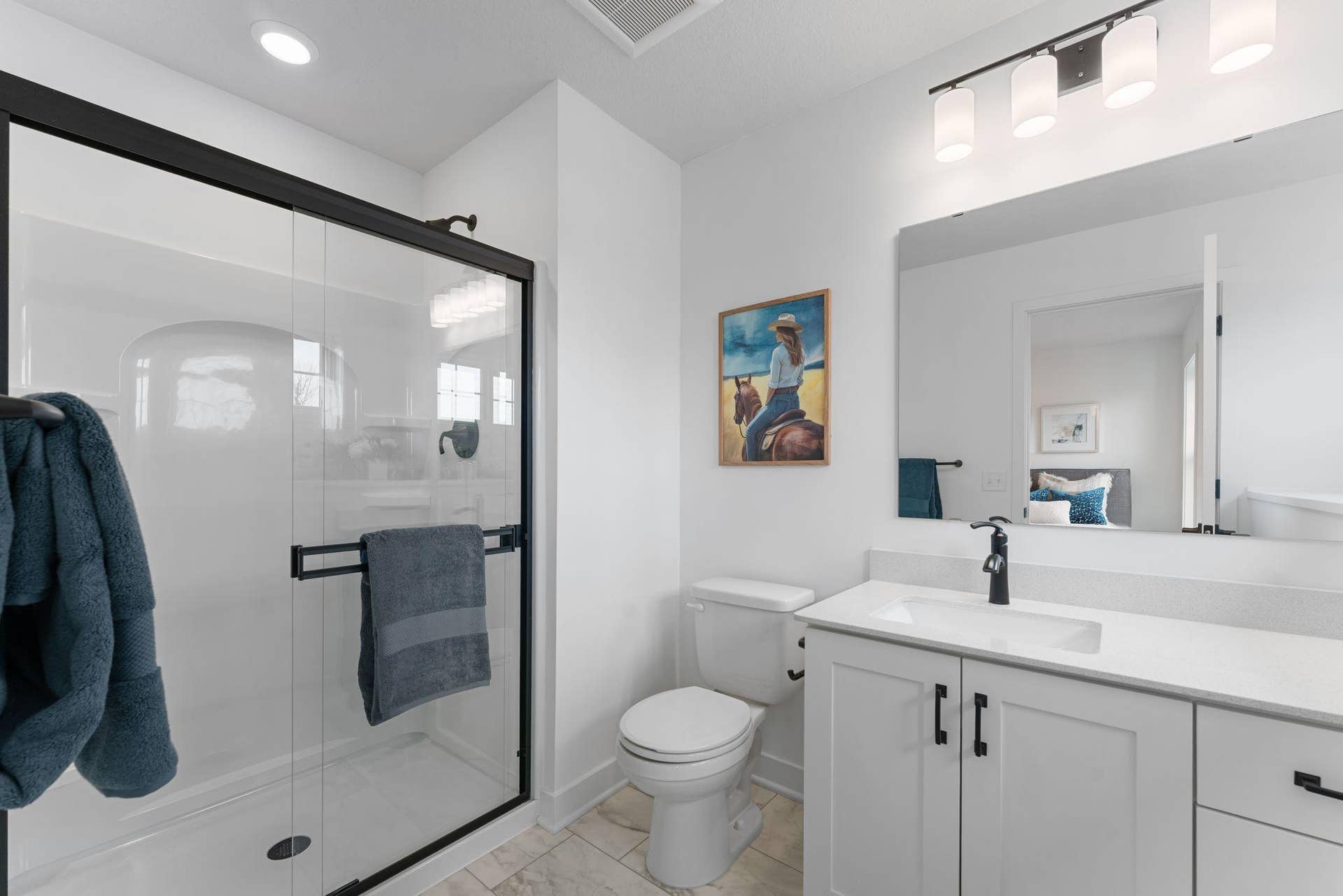 1848 Royal Boulevard N, Lake Elmo, MN 55042 Accessible from the adjoining bedroom, this en-suite bathroom offers a stylish vanity and a glass-enclosed shower.