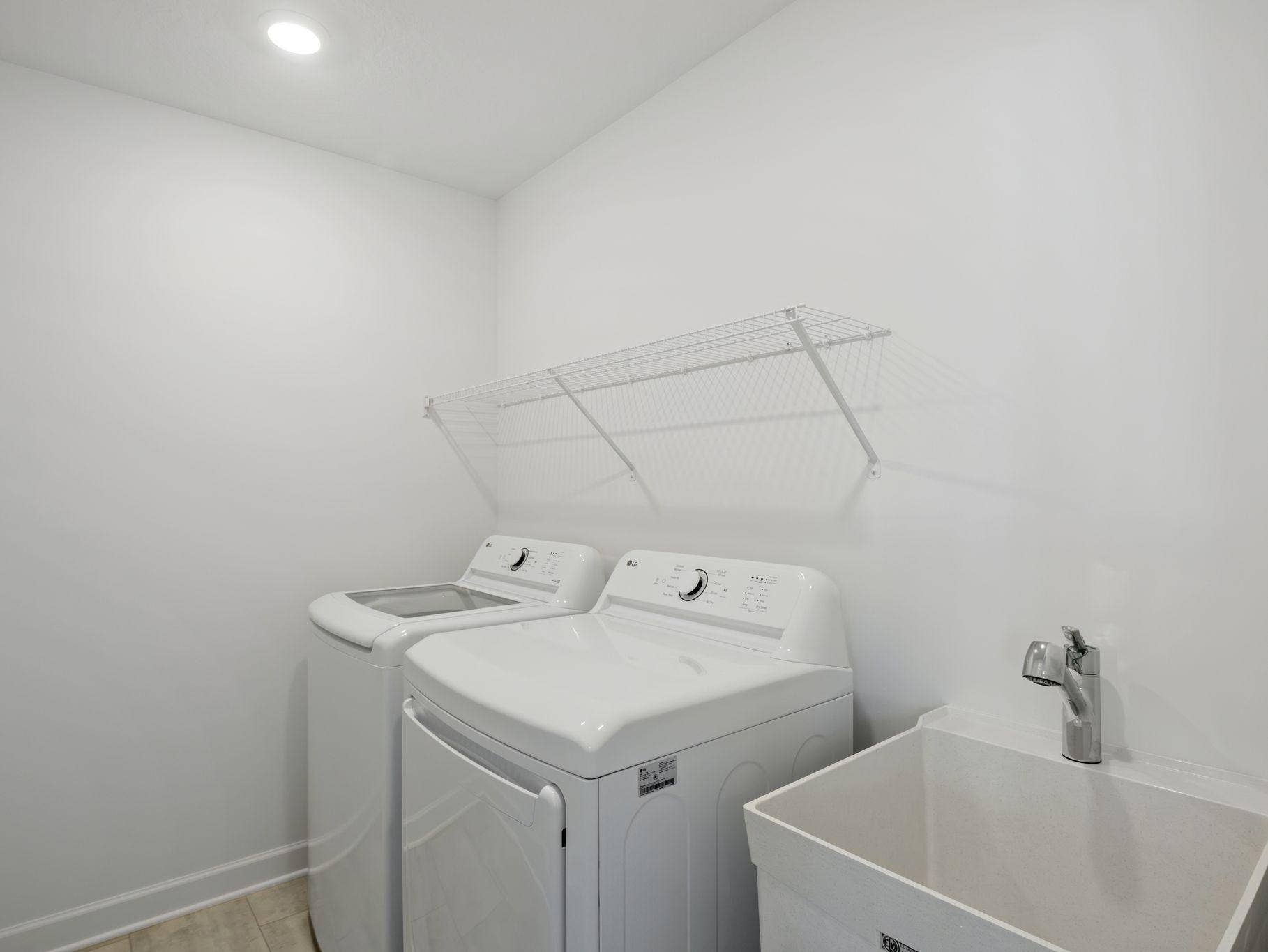 8656 Periwinkle Boulevard, Woodbury, MN 55129 The laundry room will simplify chore days with an overhead shelf and washer-dryer connections.