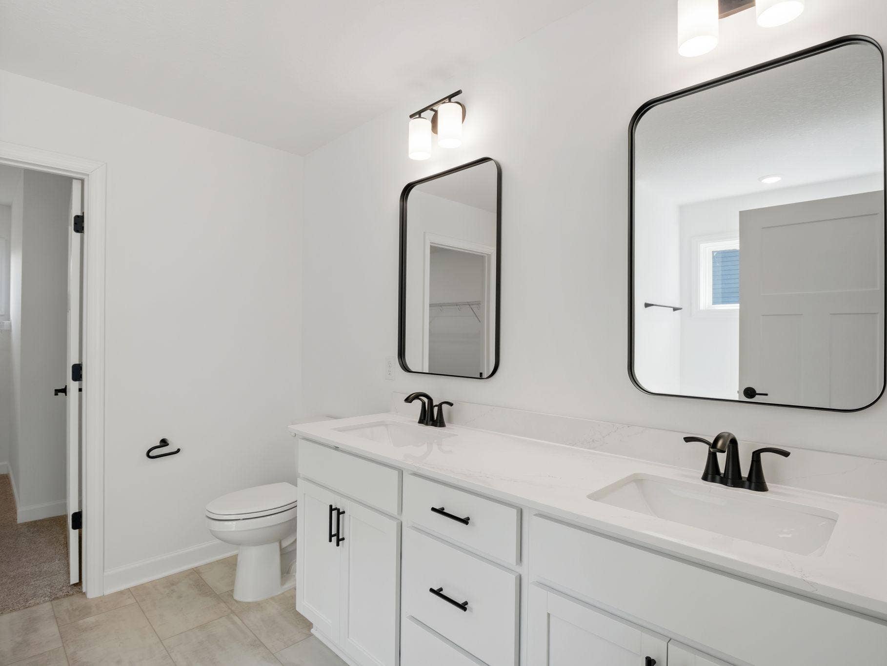 8656 Periwinkle Boulevard, Woodbury, MN 55129 The en-suite bathroom has dual sinks to simplify any morning routine